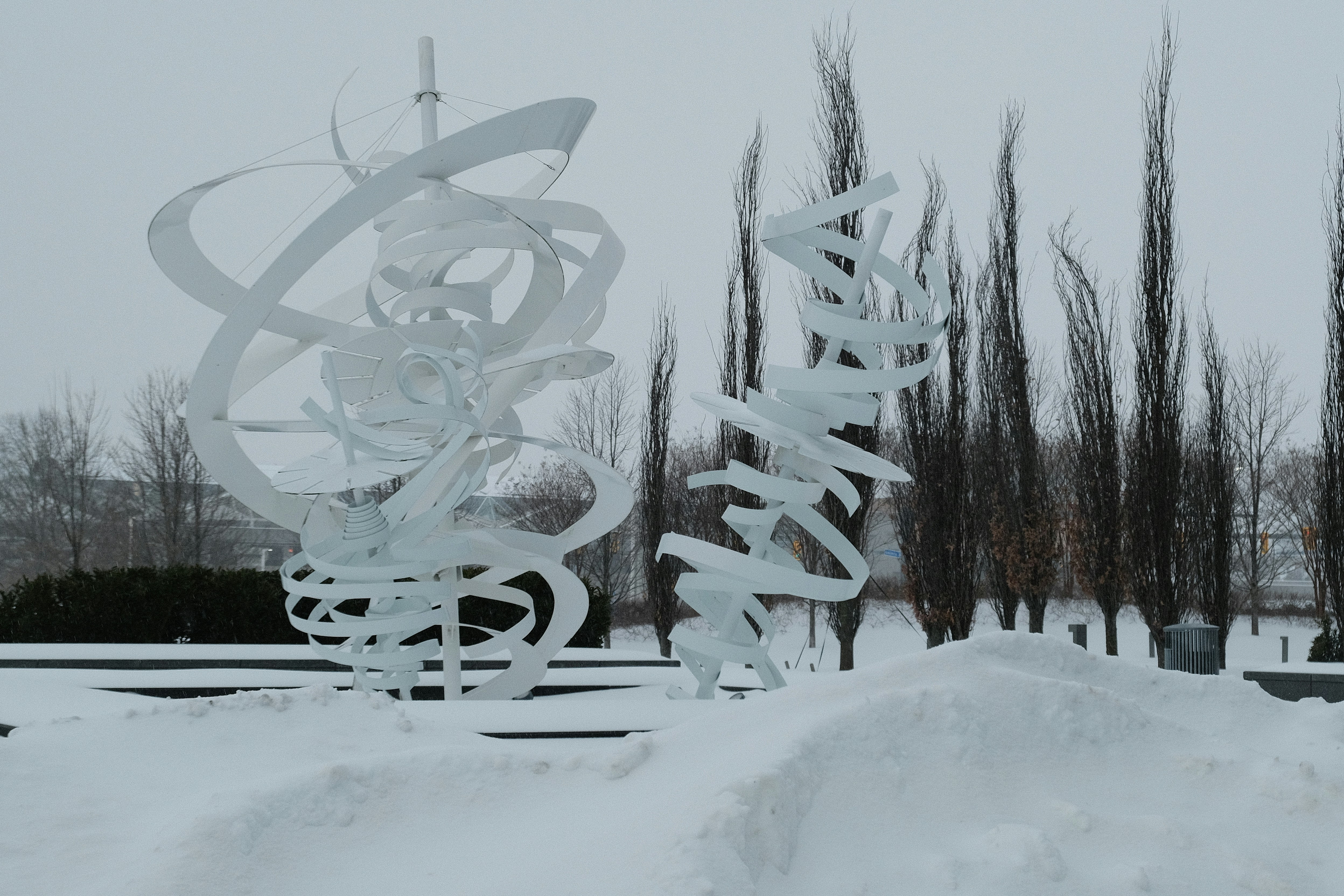 Two abstract white sculptures in the snow