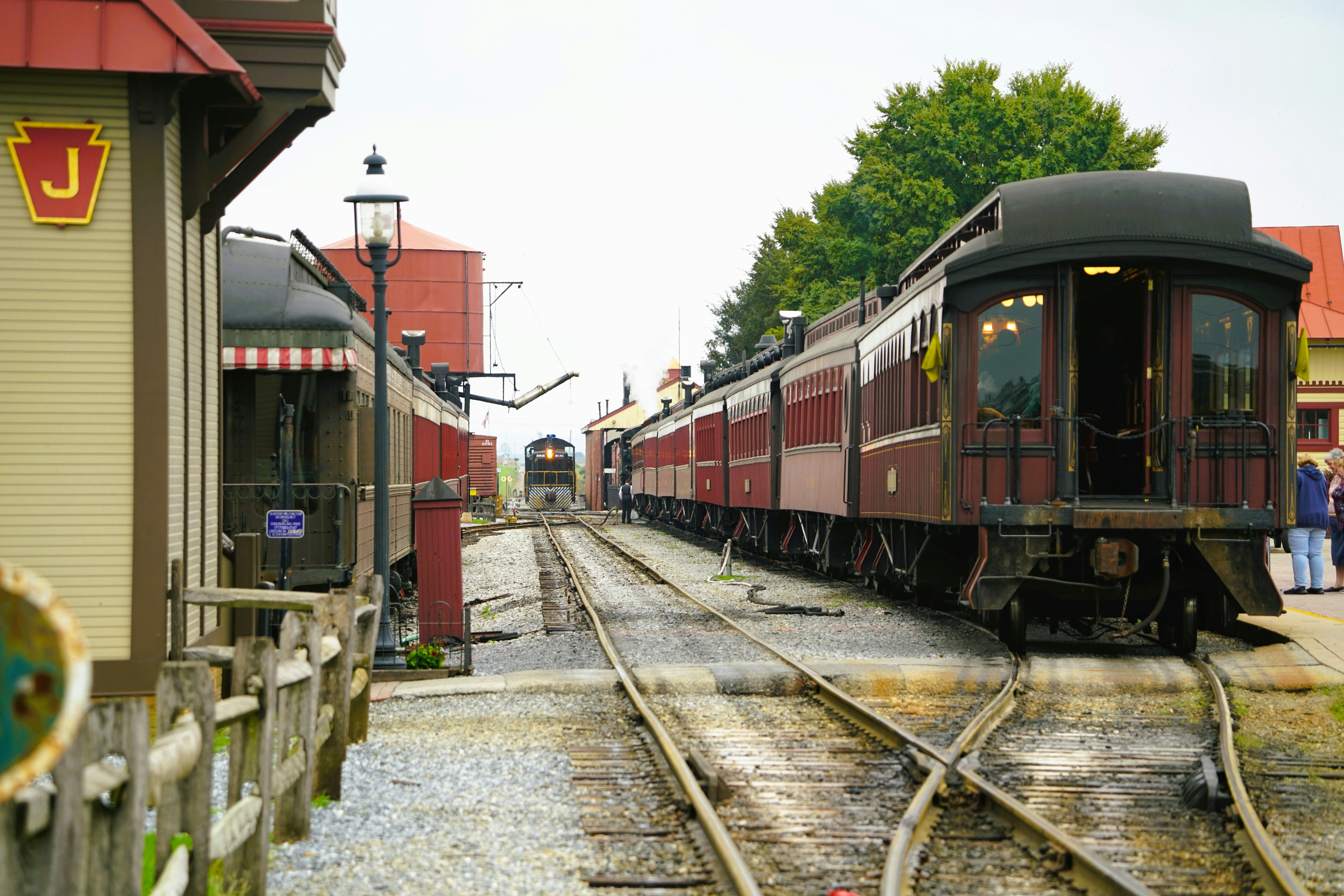 Vintage trains at a station on a cloudy day