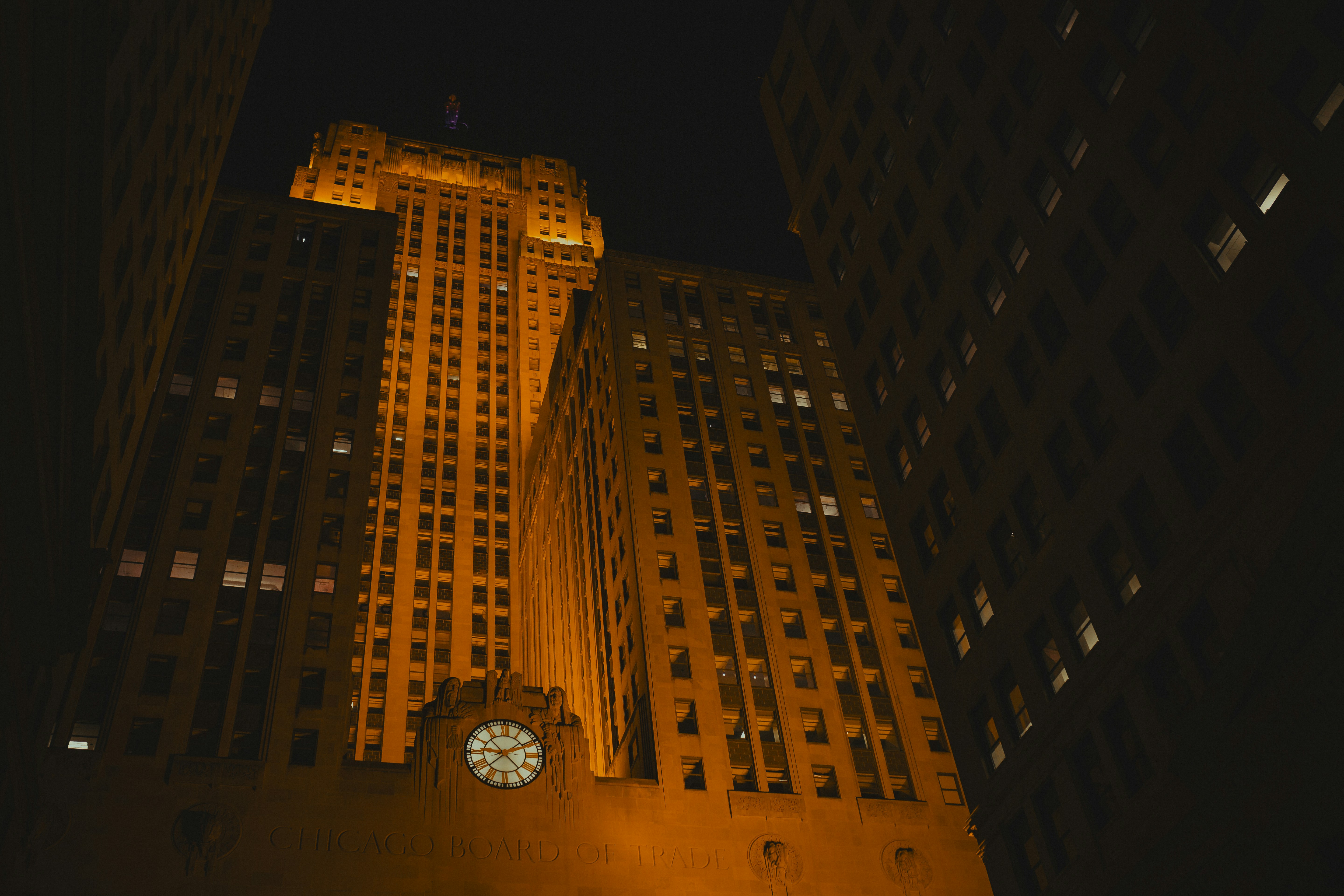 Tall illuminated buildings at night in a city