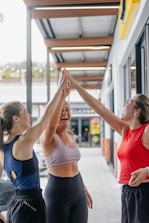 Three women giving each other a high five