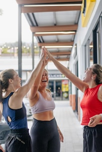 Three women giving each other a high five