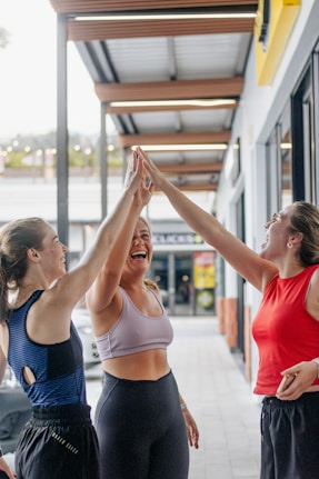Three women giving each other a high five