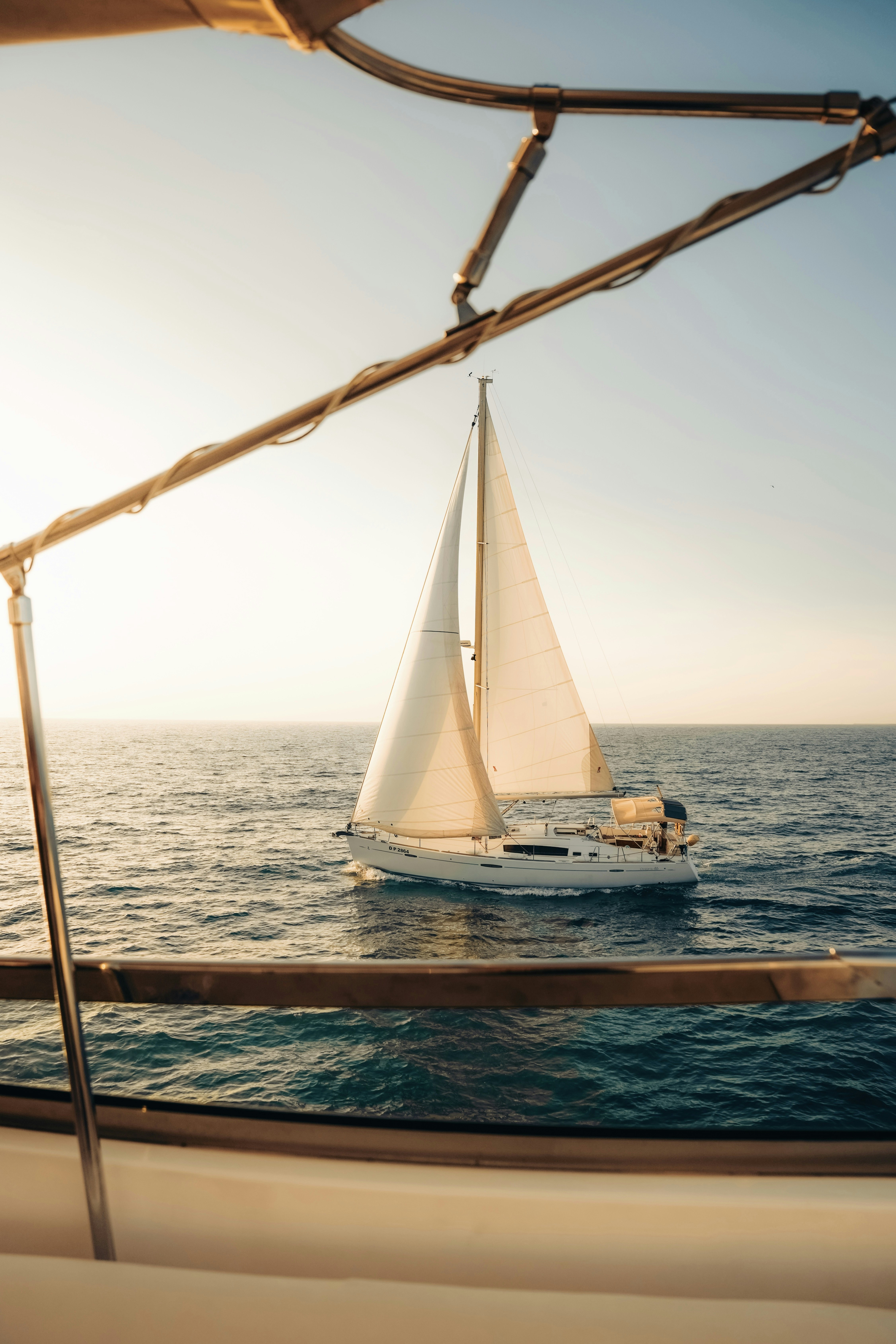 Sailboat sailing on the ocean at sunset
