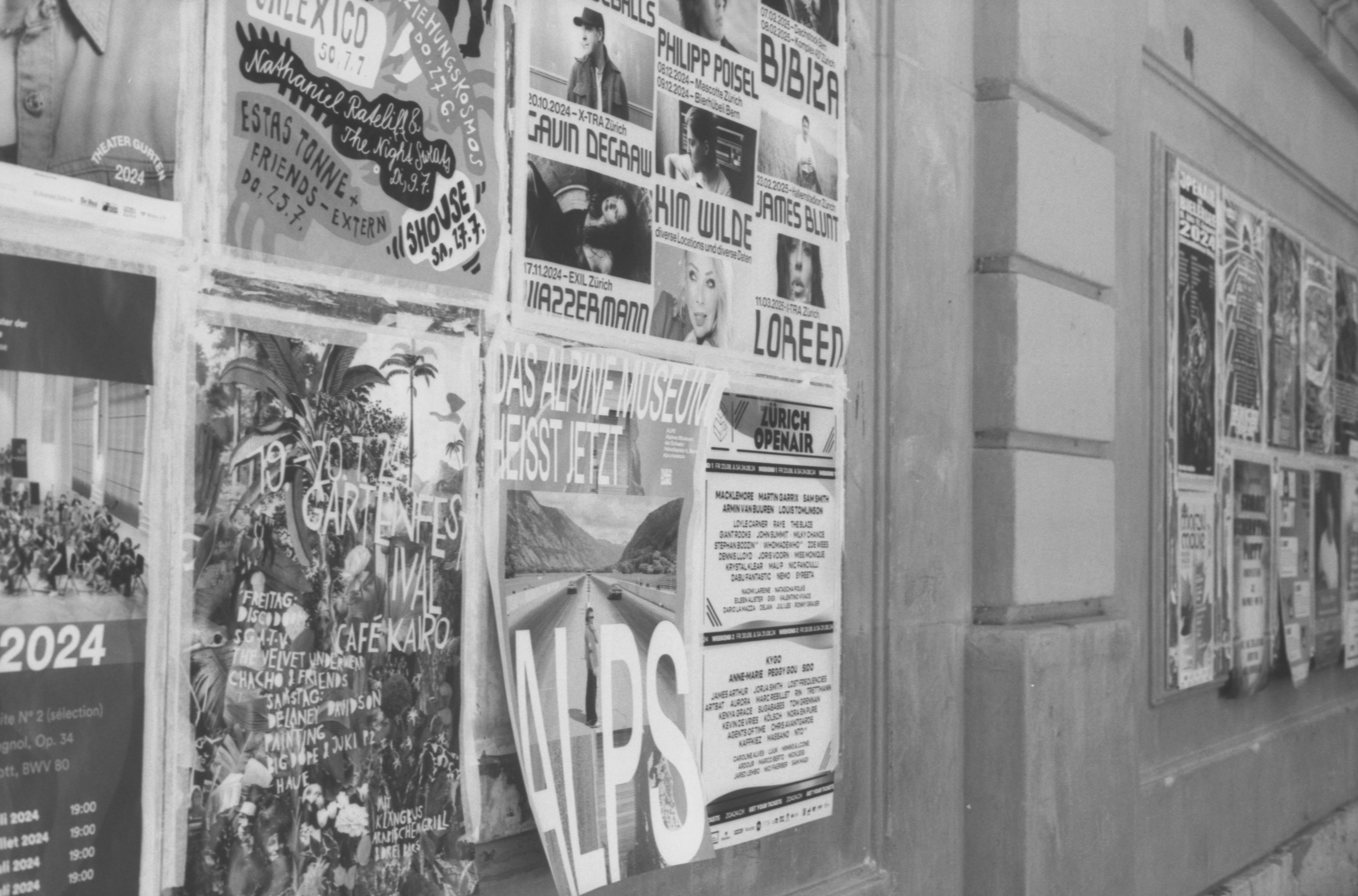Wall covered with various posters and flyers