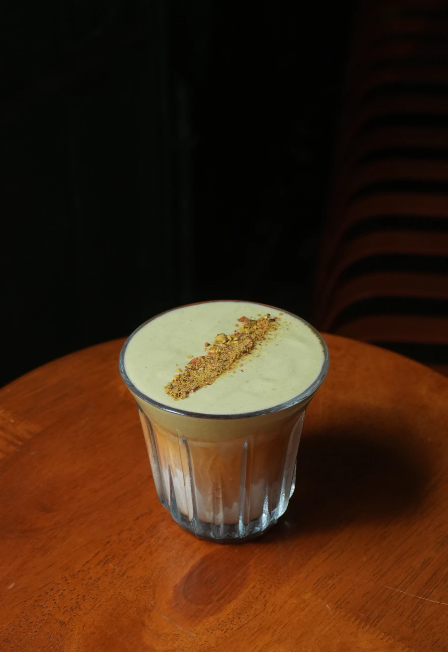 Creamy latte topped with spice on a wooden table