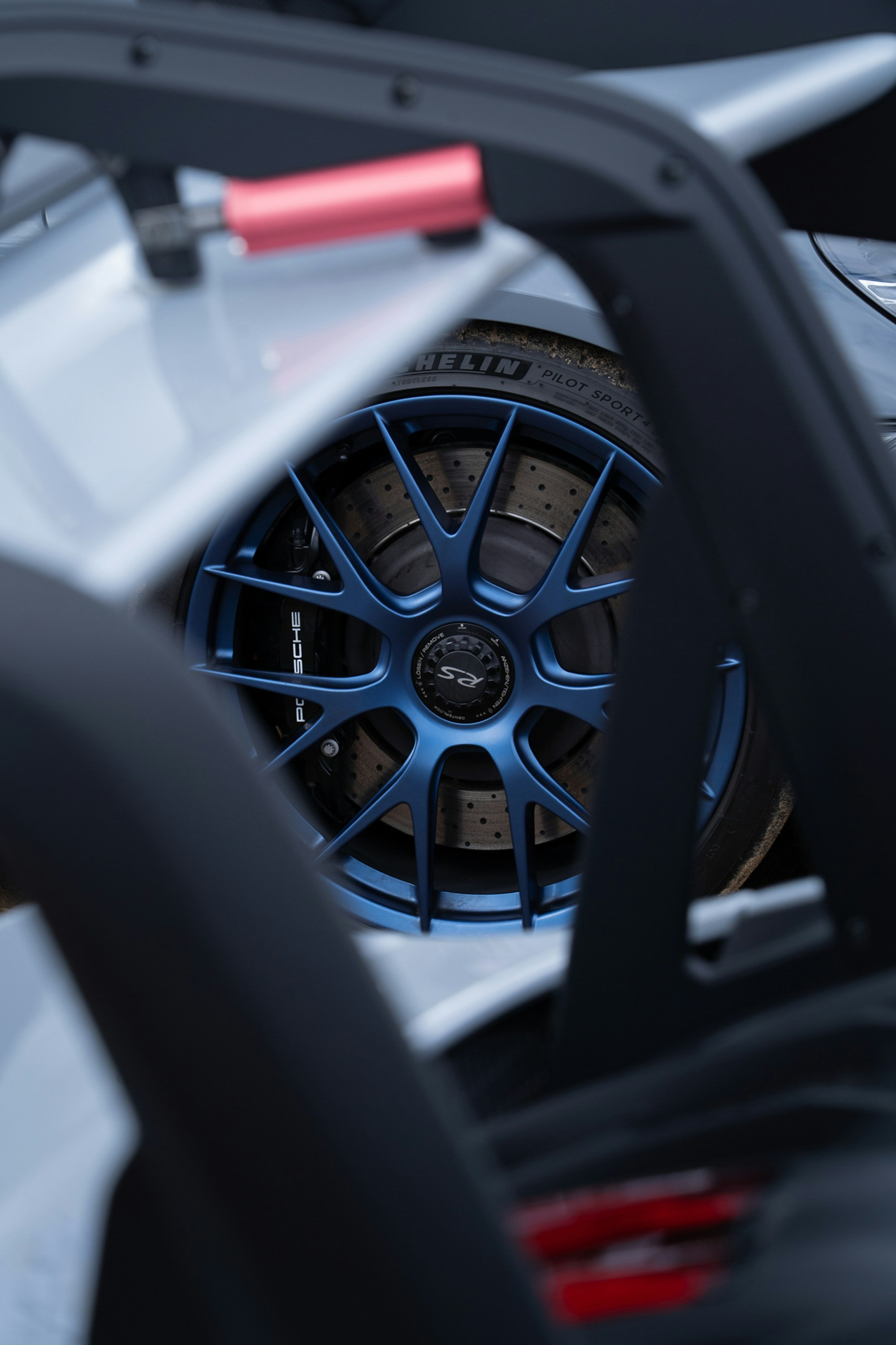 Close-up of a blue car wheel with brake rotor.
