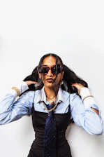Woman in sunglasses and tie with striped shirt