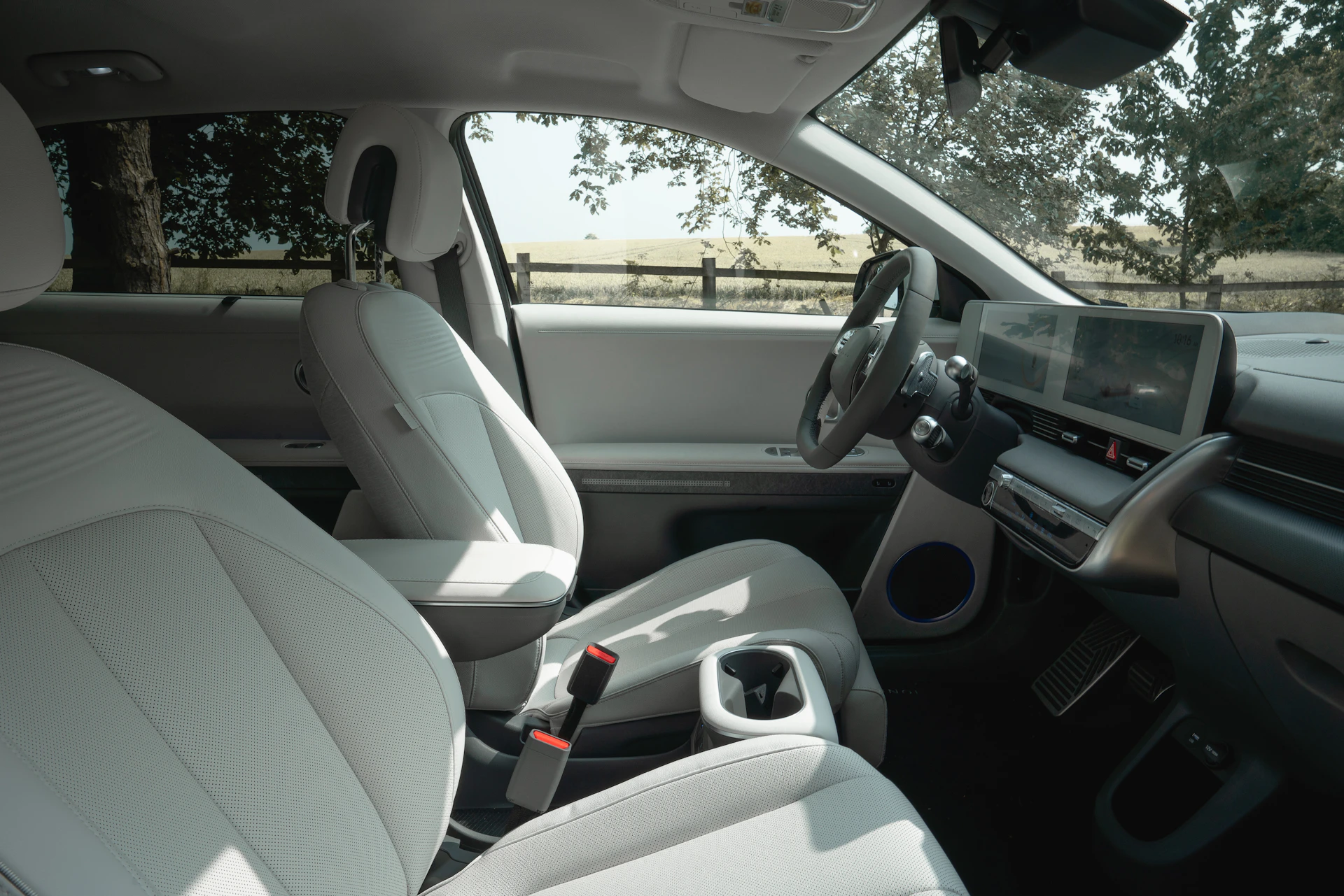 Interior view of a modern car with white seats