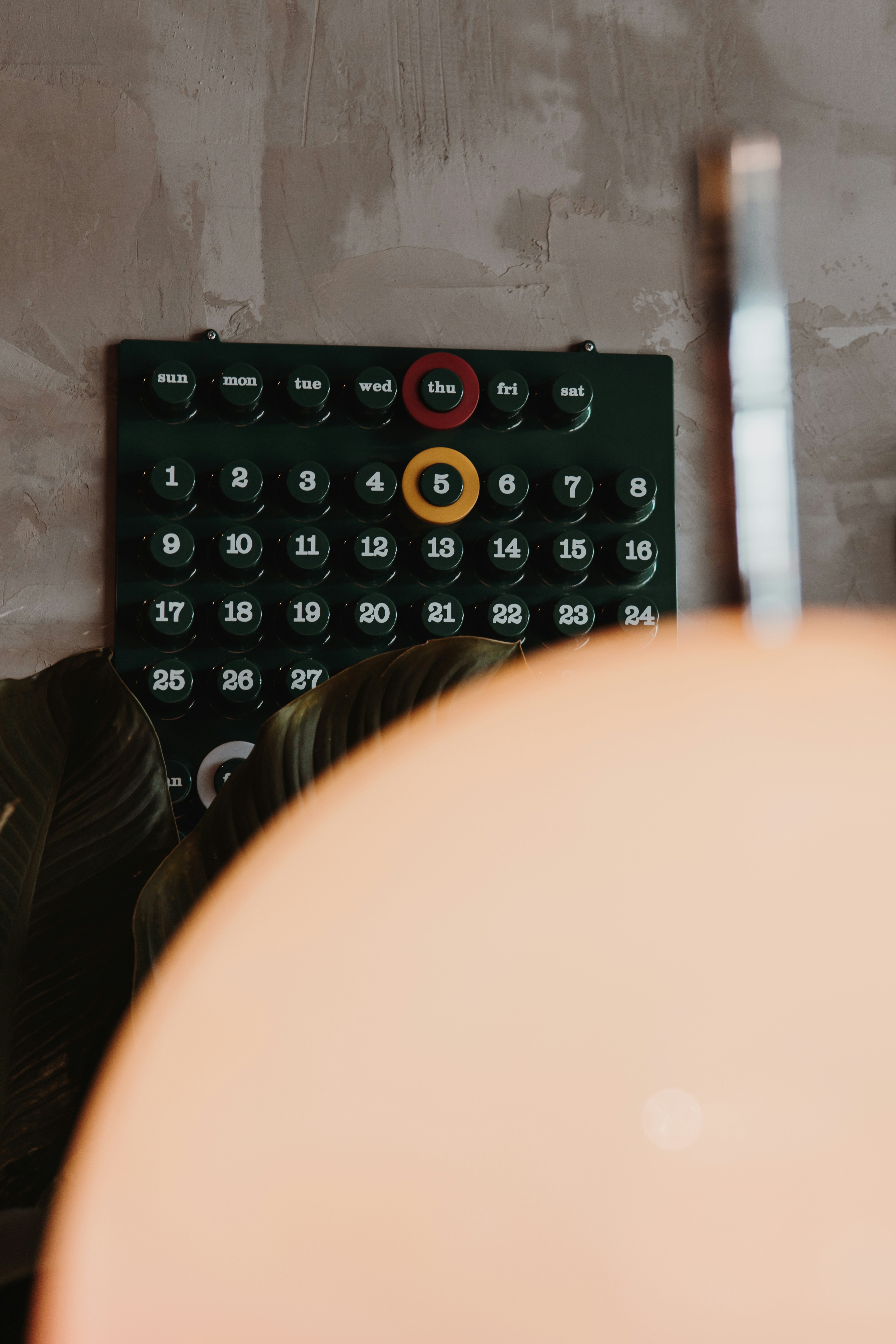 A dark calendar with numbered days and highlighted dates.