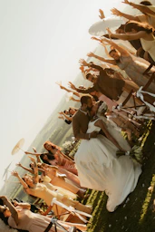 Bride and groom kiss as guests wave and cheer
