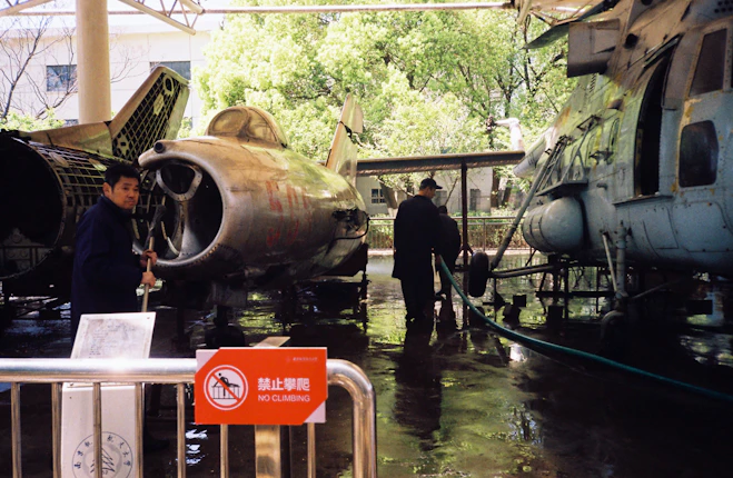 Two aircraft and a helicopter on display