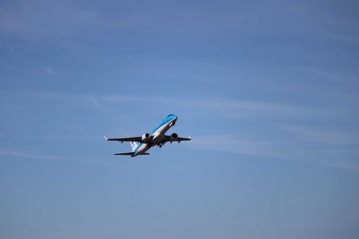 A commercial jetliner taking off into a blue sky representing India's massive Boeing aircraft order
