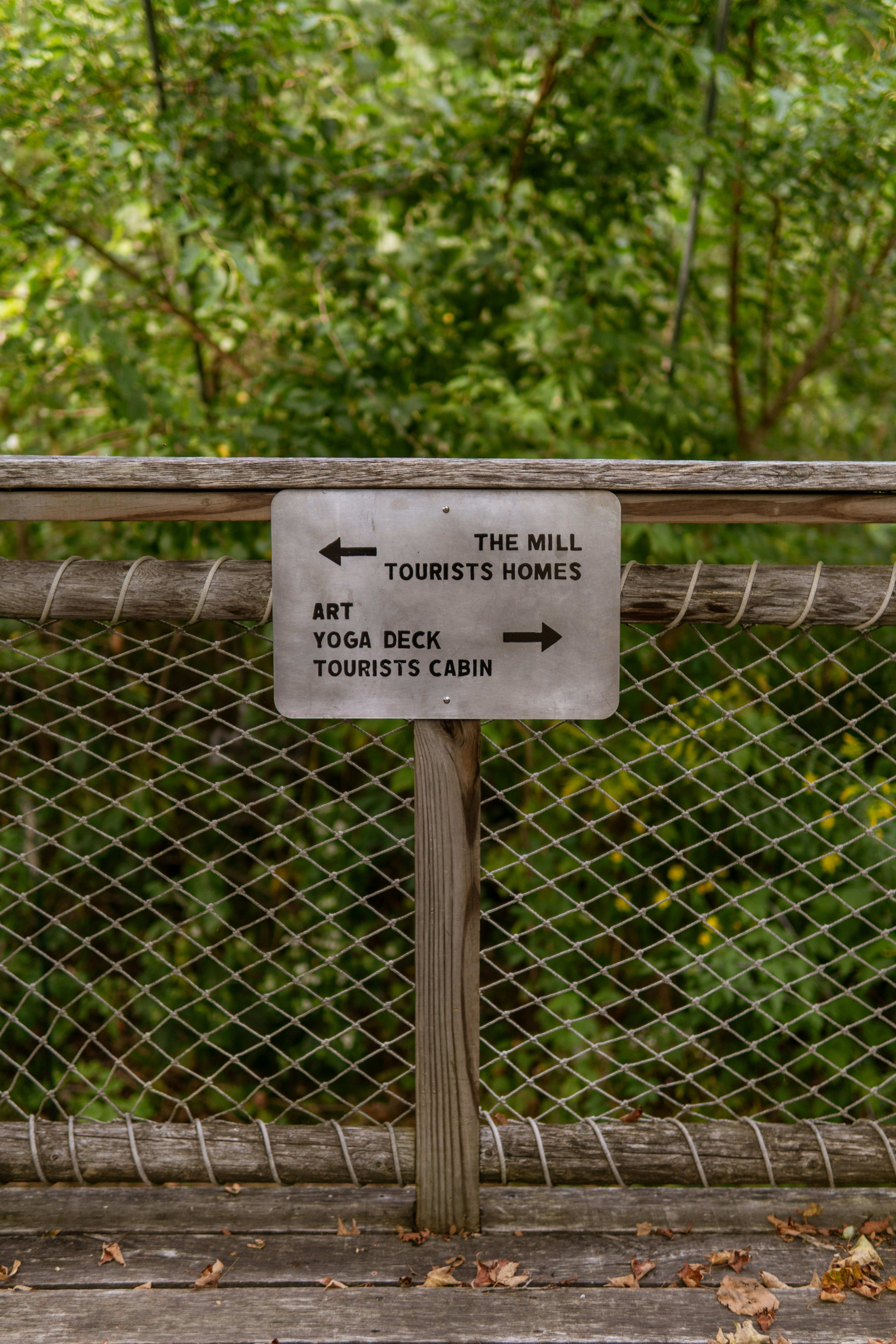 Signpost with directions to art, yoga, and mill homes