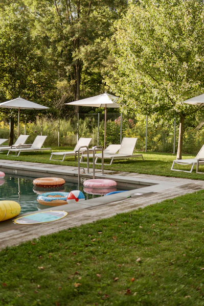 Swimming pool with inflatable rings and lounge chairs