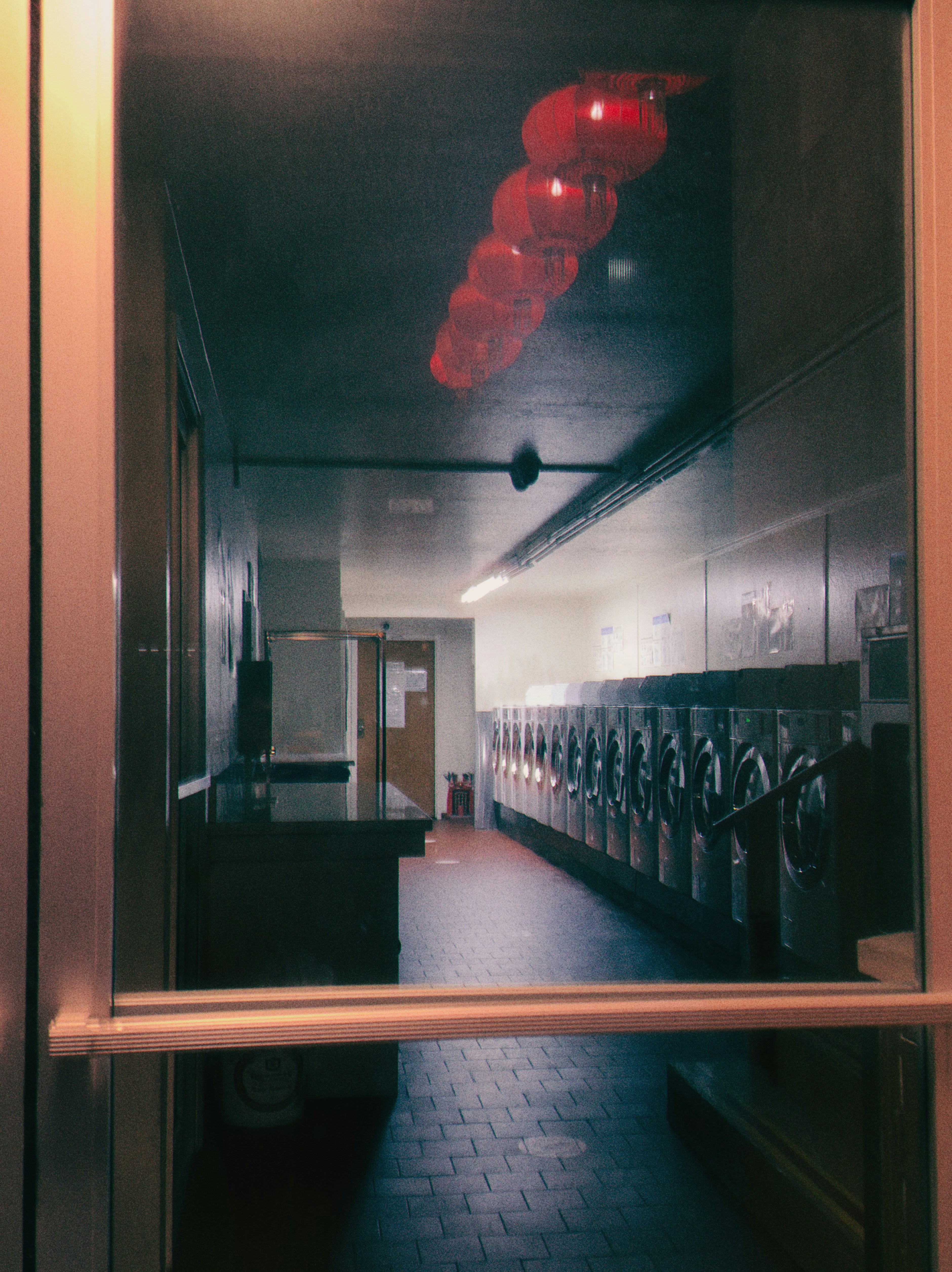 Hallway with row of washing machines and red lanterns