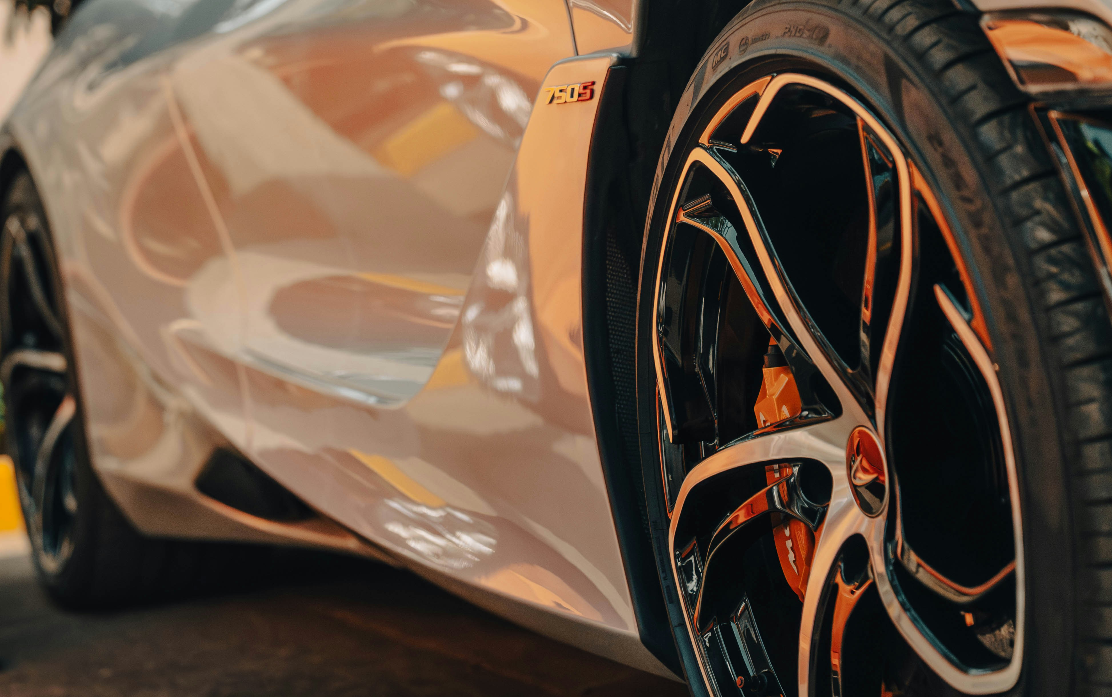 Close-up of a shiny white sports car wheel