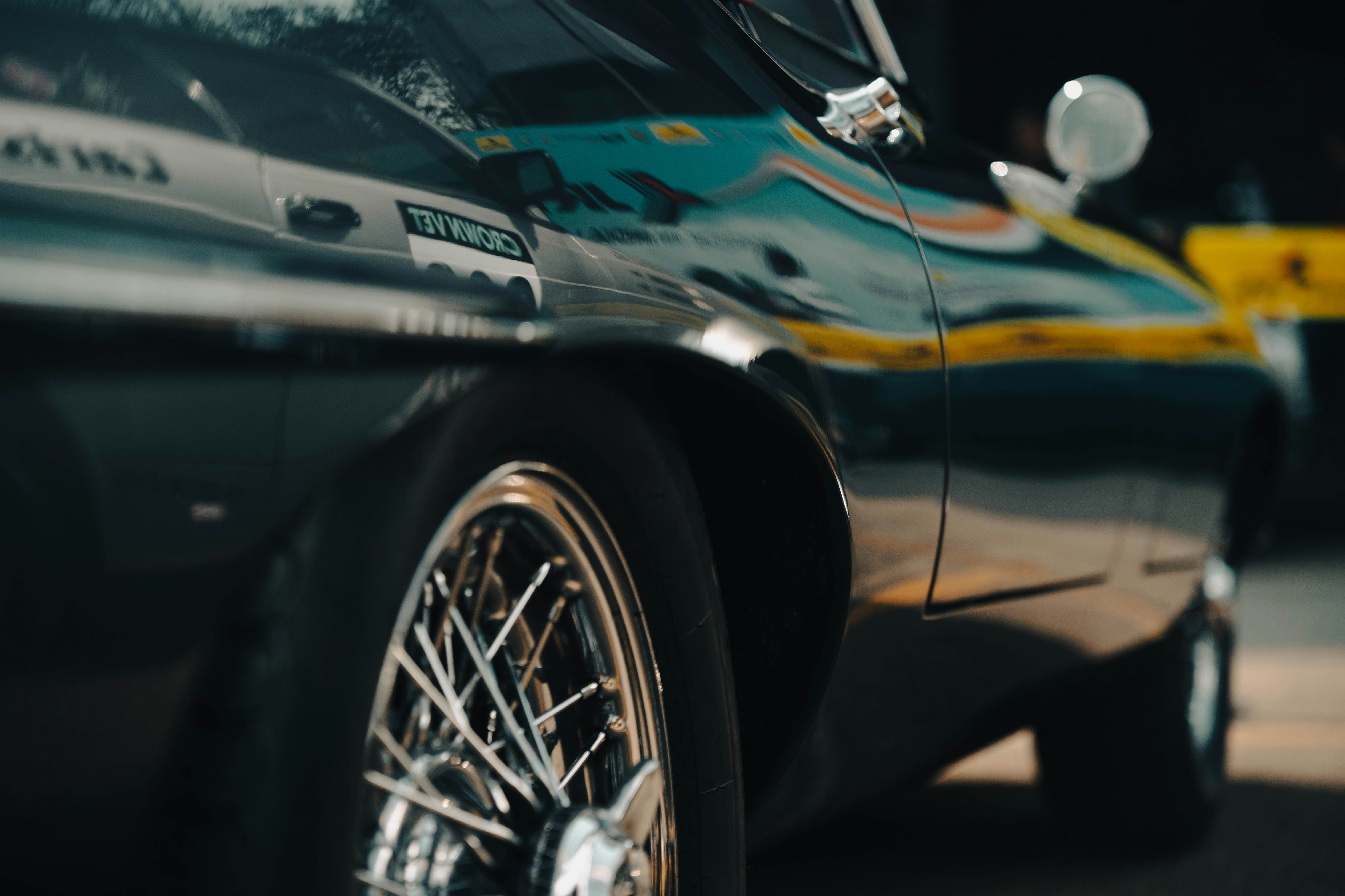 Close-up of a vintage car's shiny black exterior.