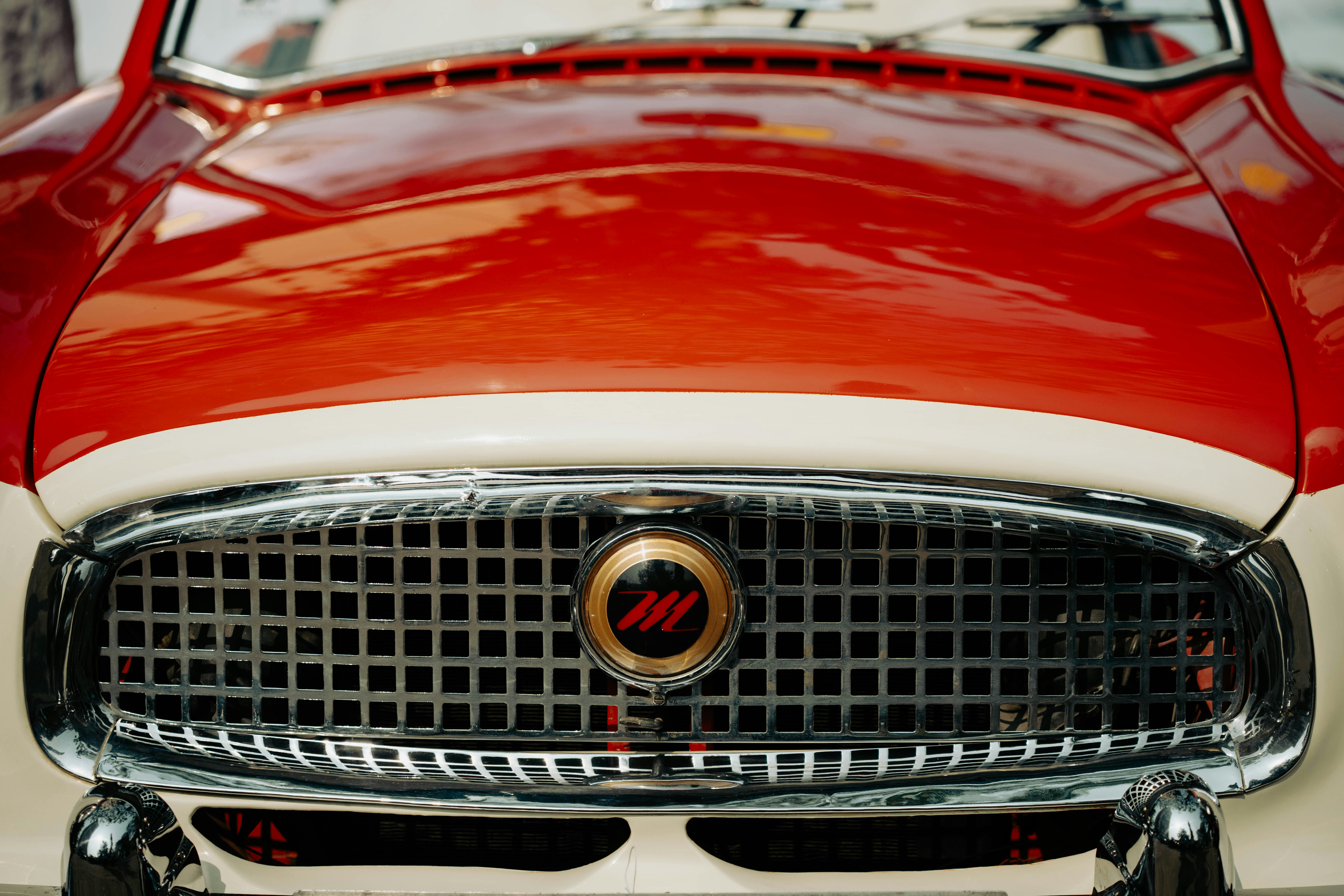 Close-up of a vintage red and white car grille