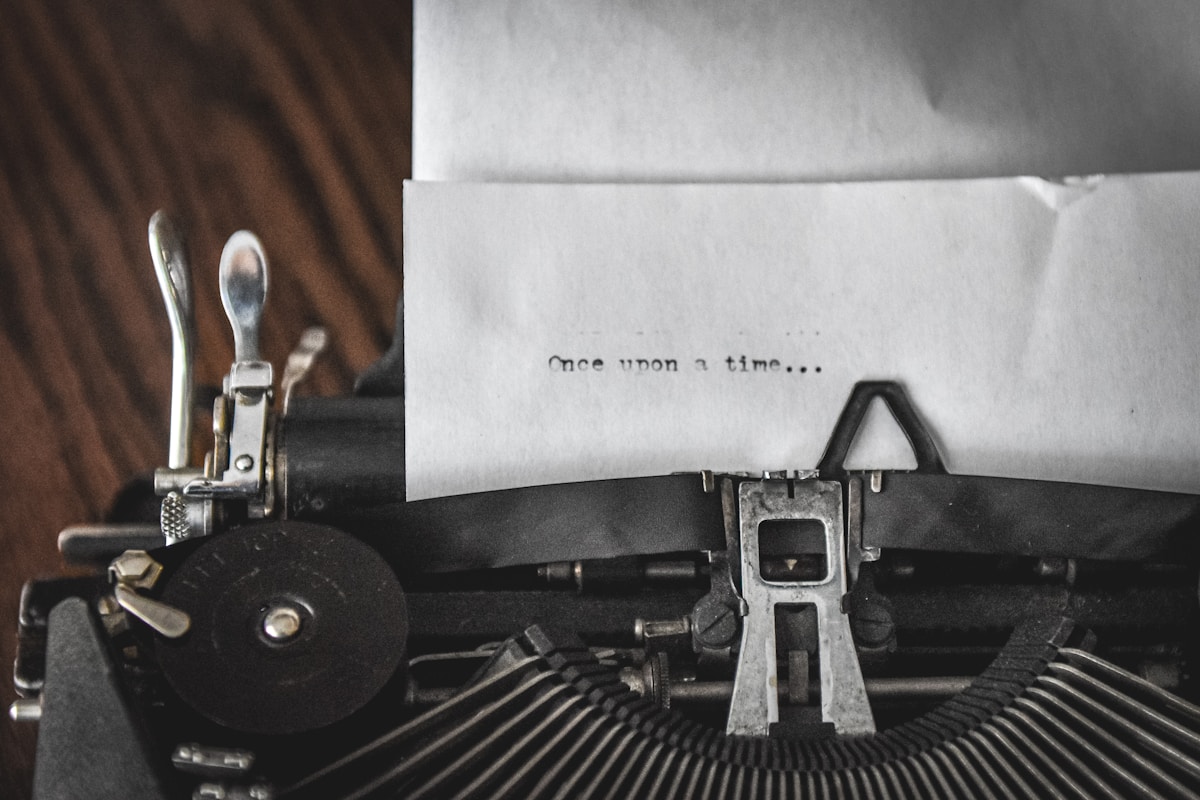 Vintage typewriter with paper reading once upon a time — script writing