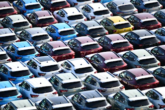 Rows of new cars parked in a large lot