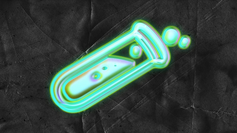 Glowing green test tube with bubbles and liquid