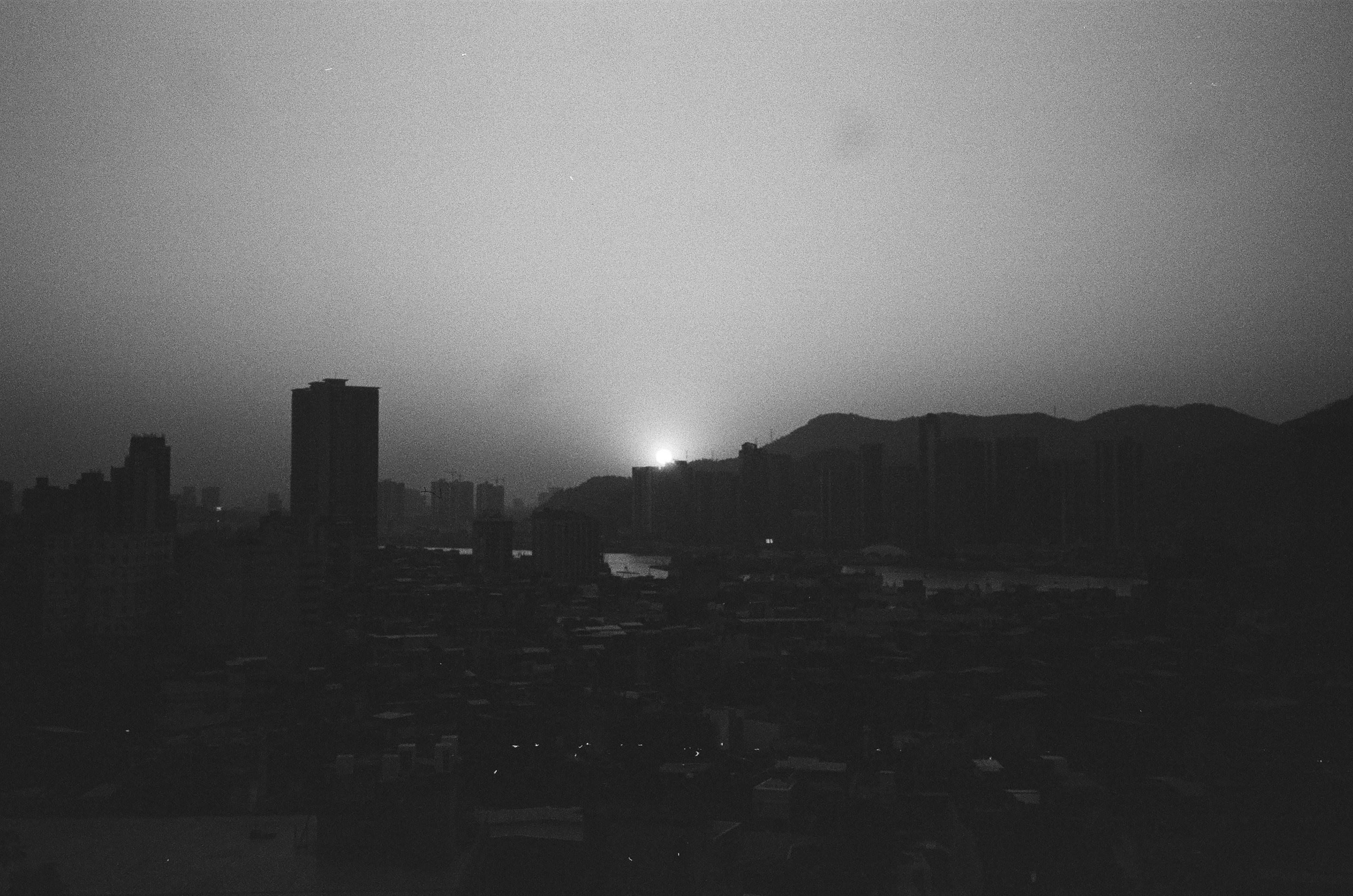 City skyline at dusk with mountains in background