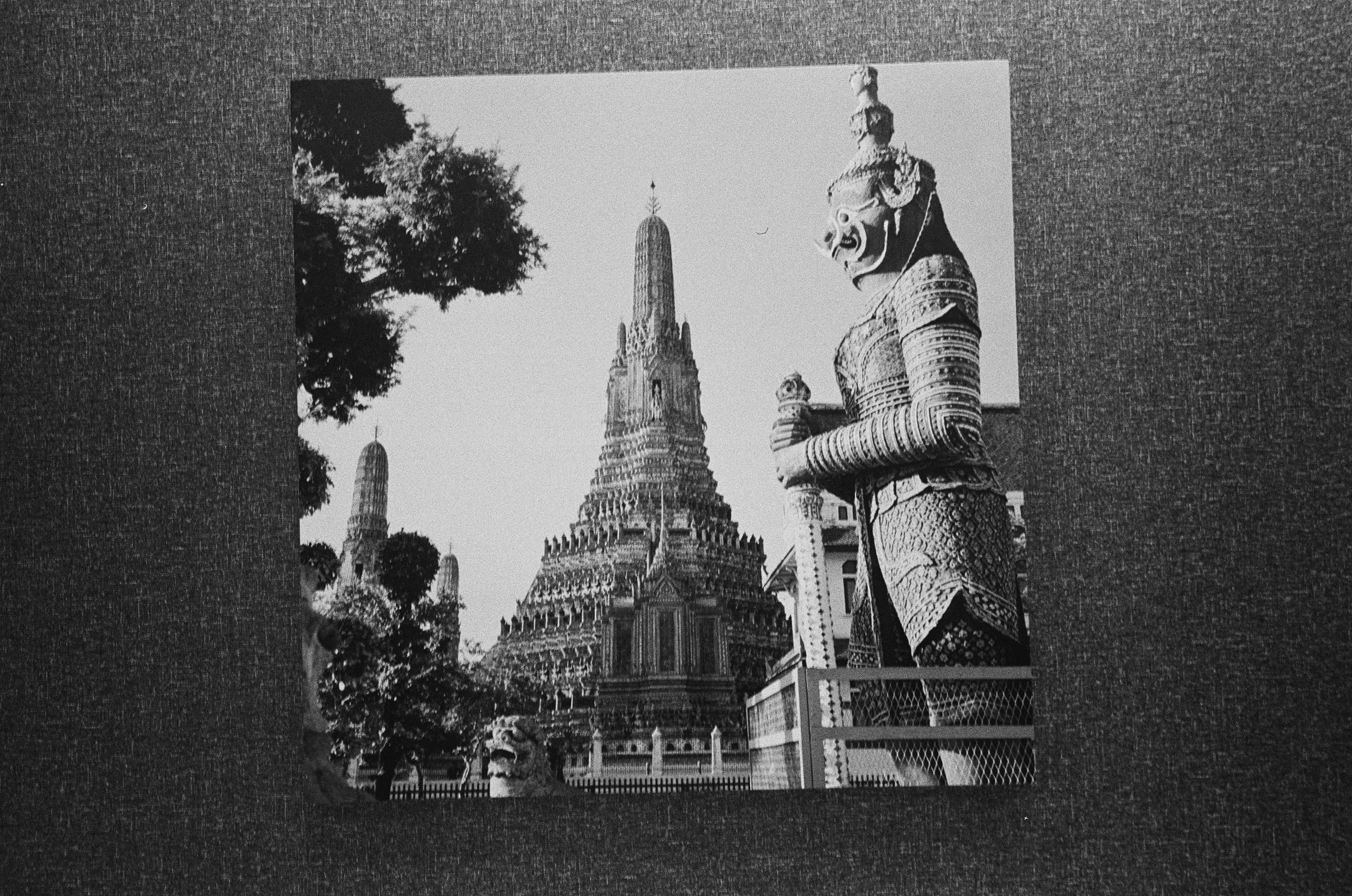 Black and white temple with a large statue.