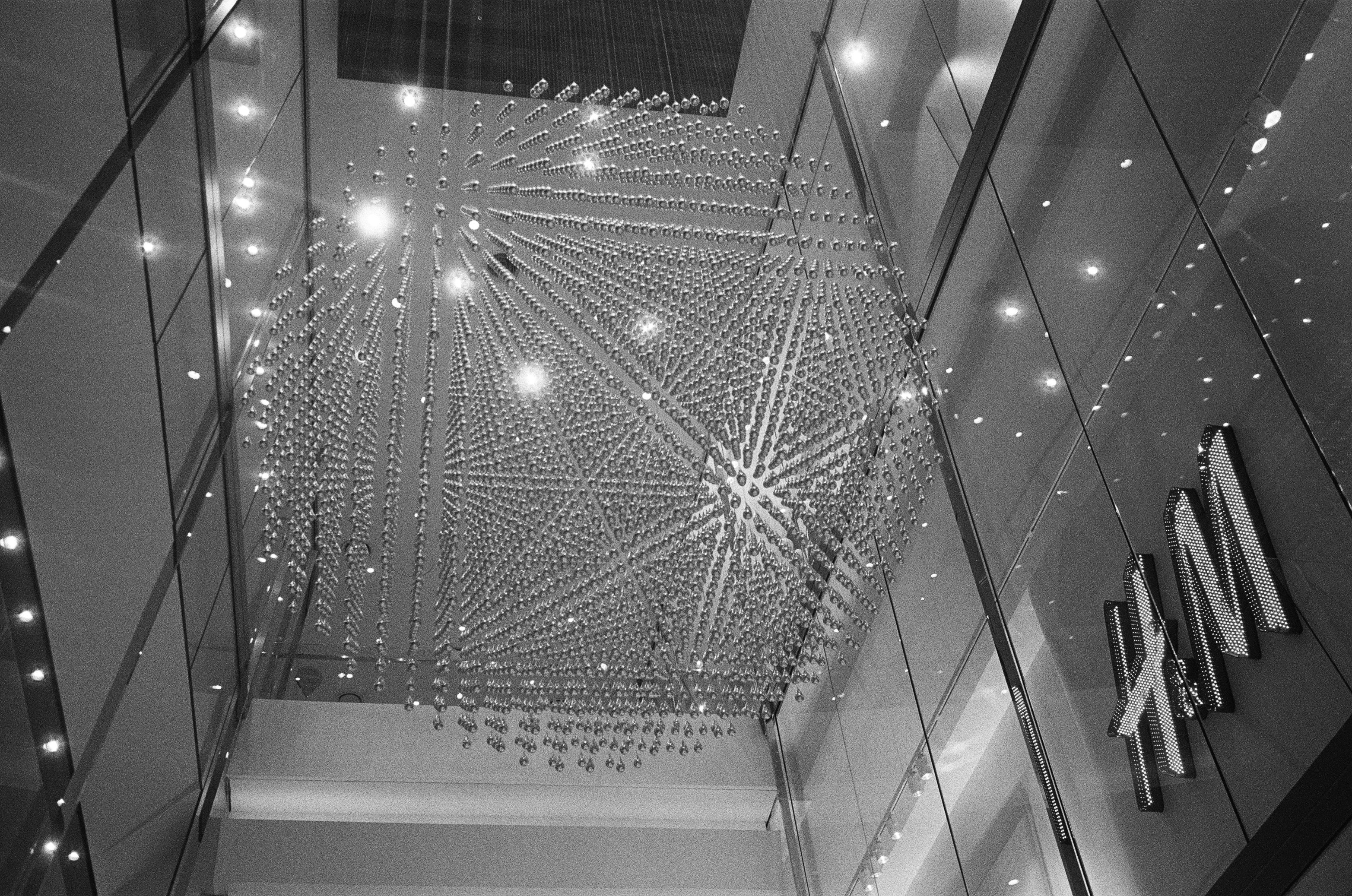Modern geometric sculpture hanging in a shopping mall.