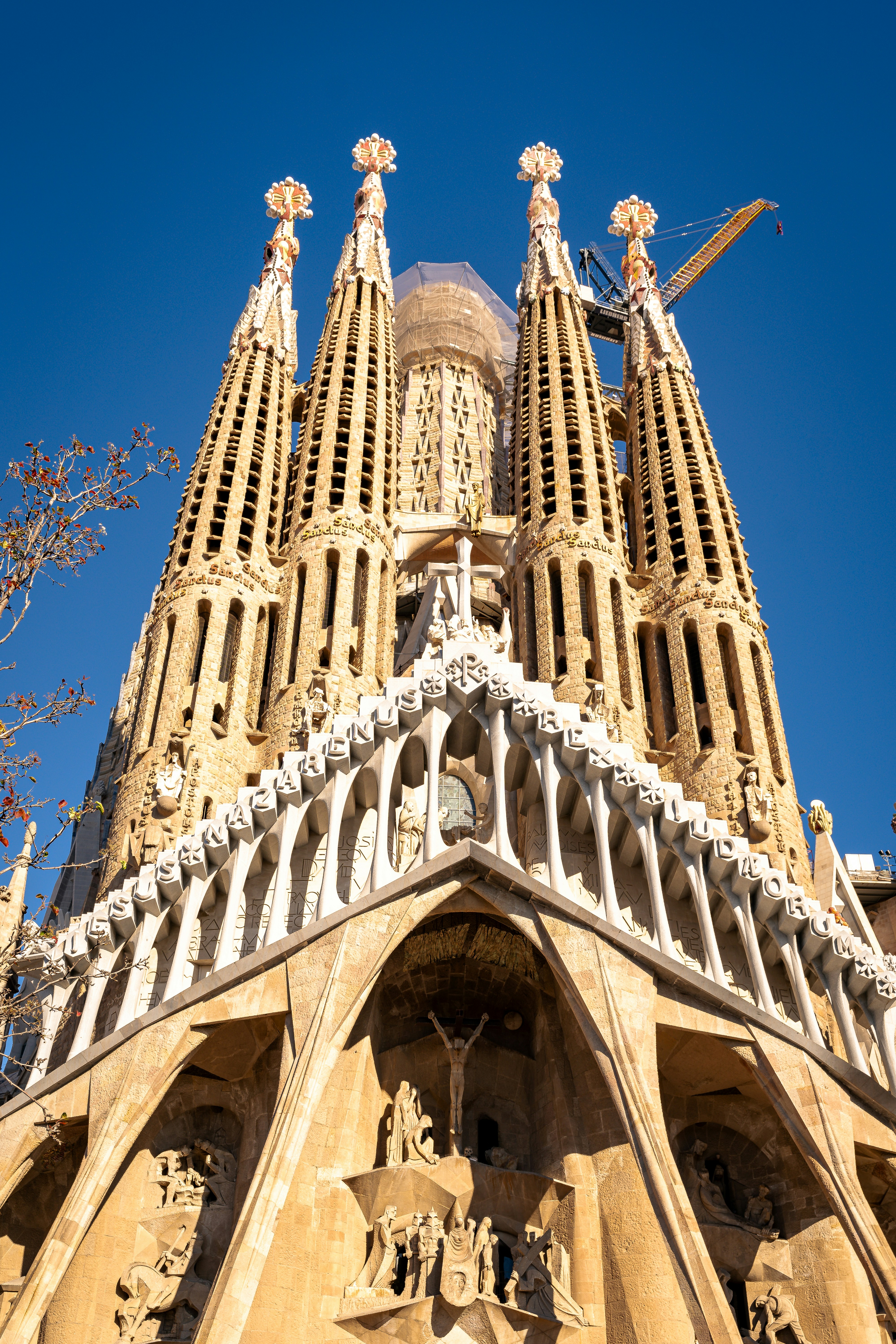 The sagrada familia basilica against a clear blue sky.