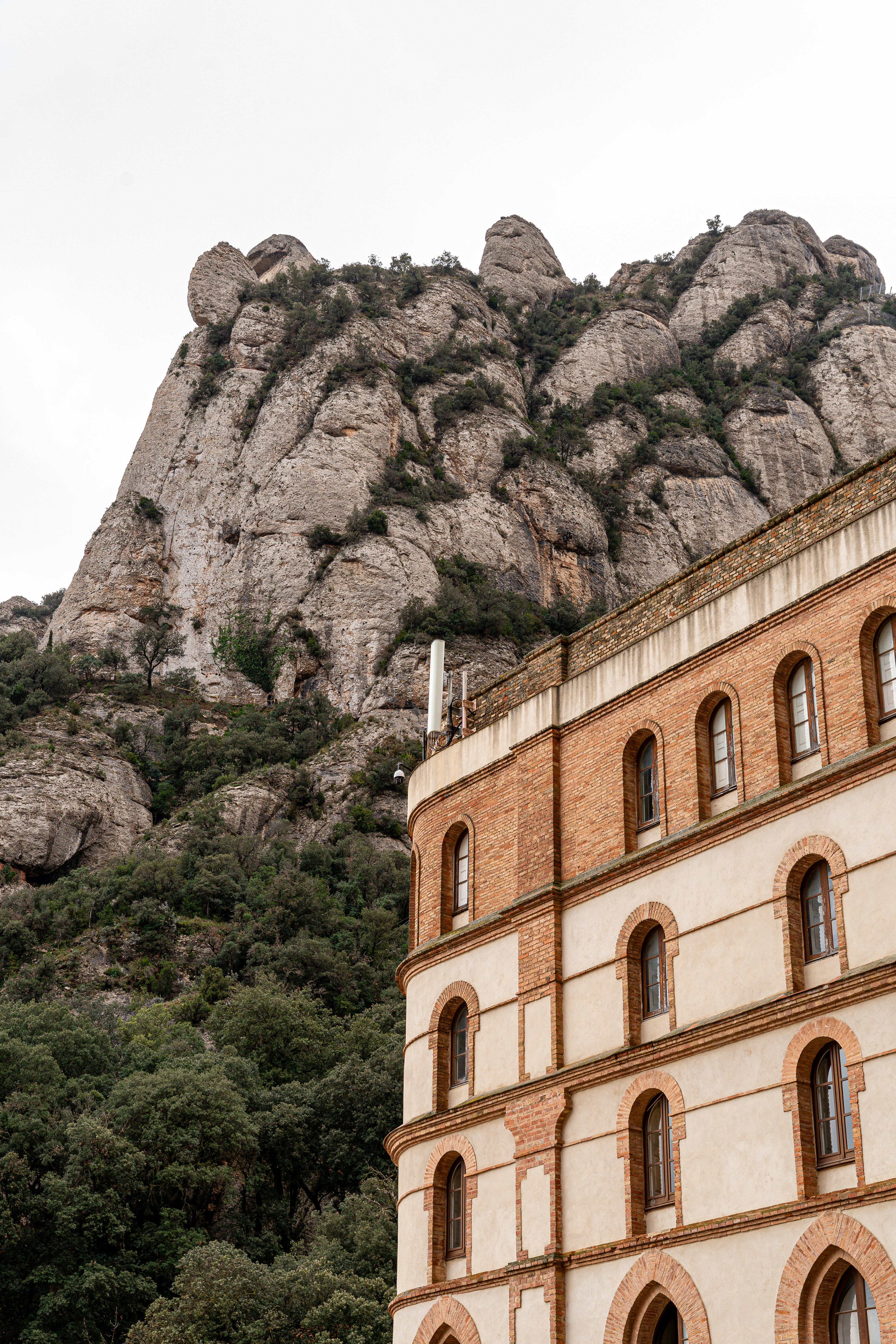 Building facade against a rocky mountain backdrop