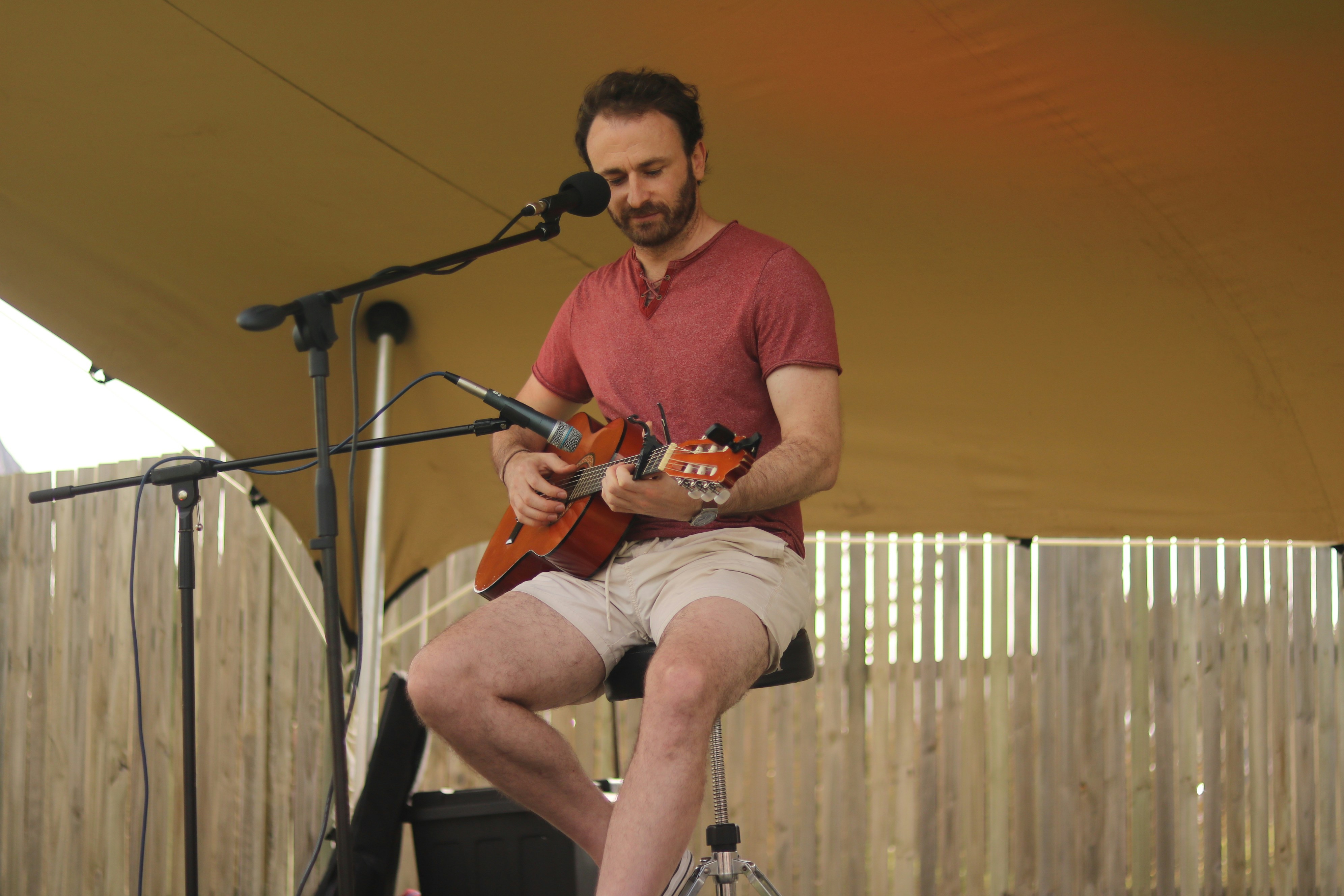 Man playing guitar and singing into microphone