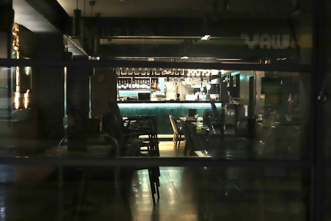 Interior of a dimly lit bar with a glowing counter, a reminder of the neighborhood bars that have served east side Las Vegas for decades
