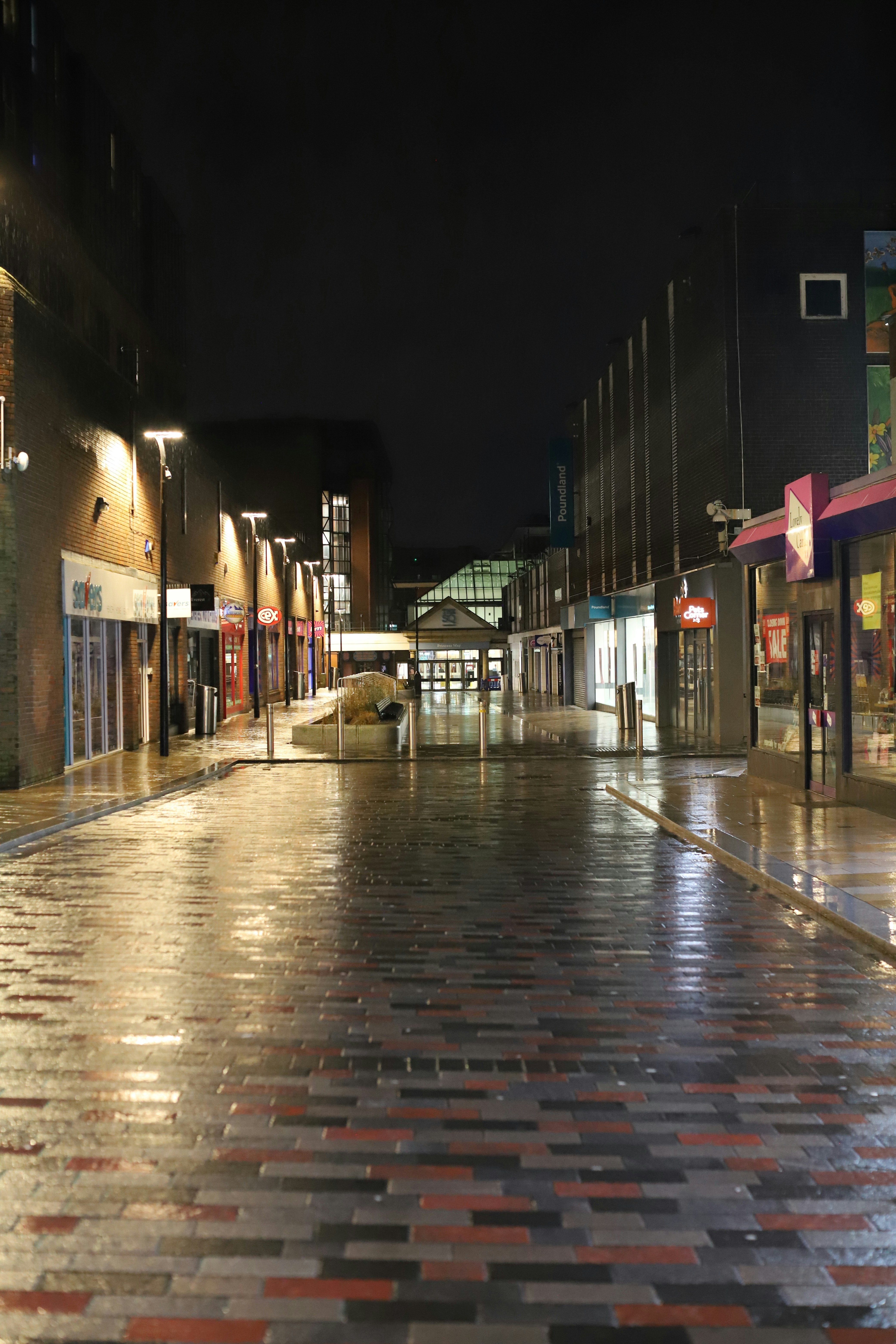 Wet street in a city at night with reflections