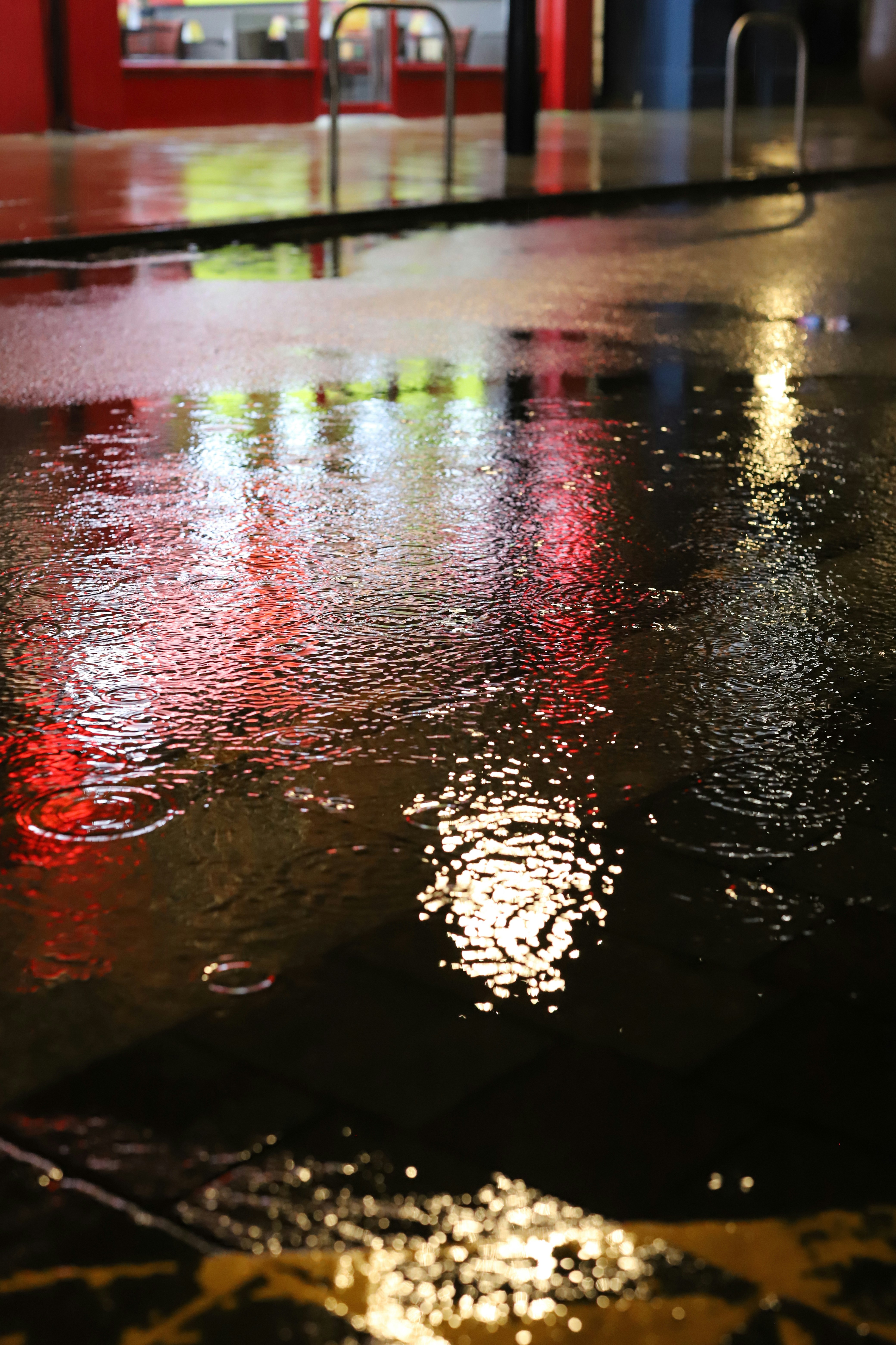 Rainy street at night with colorful reflections