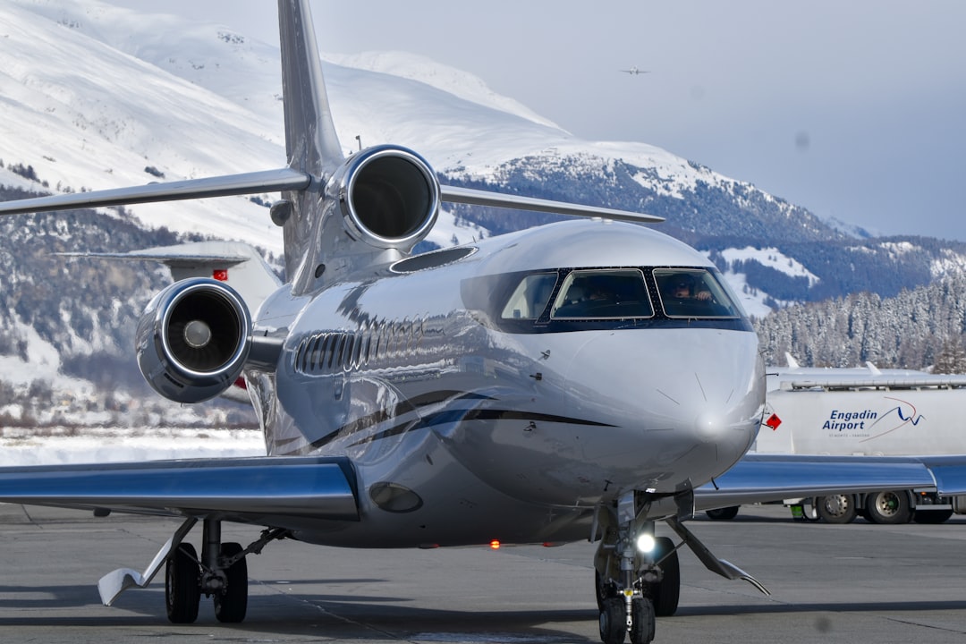 A private jet parked on an airport tarmac.