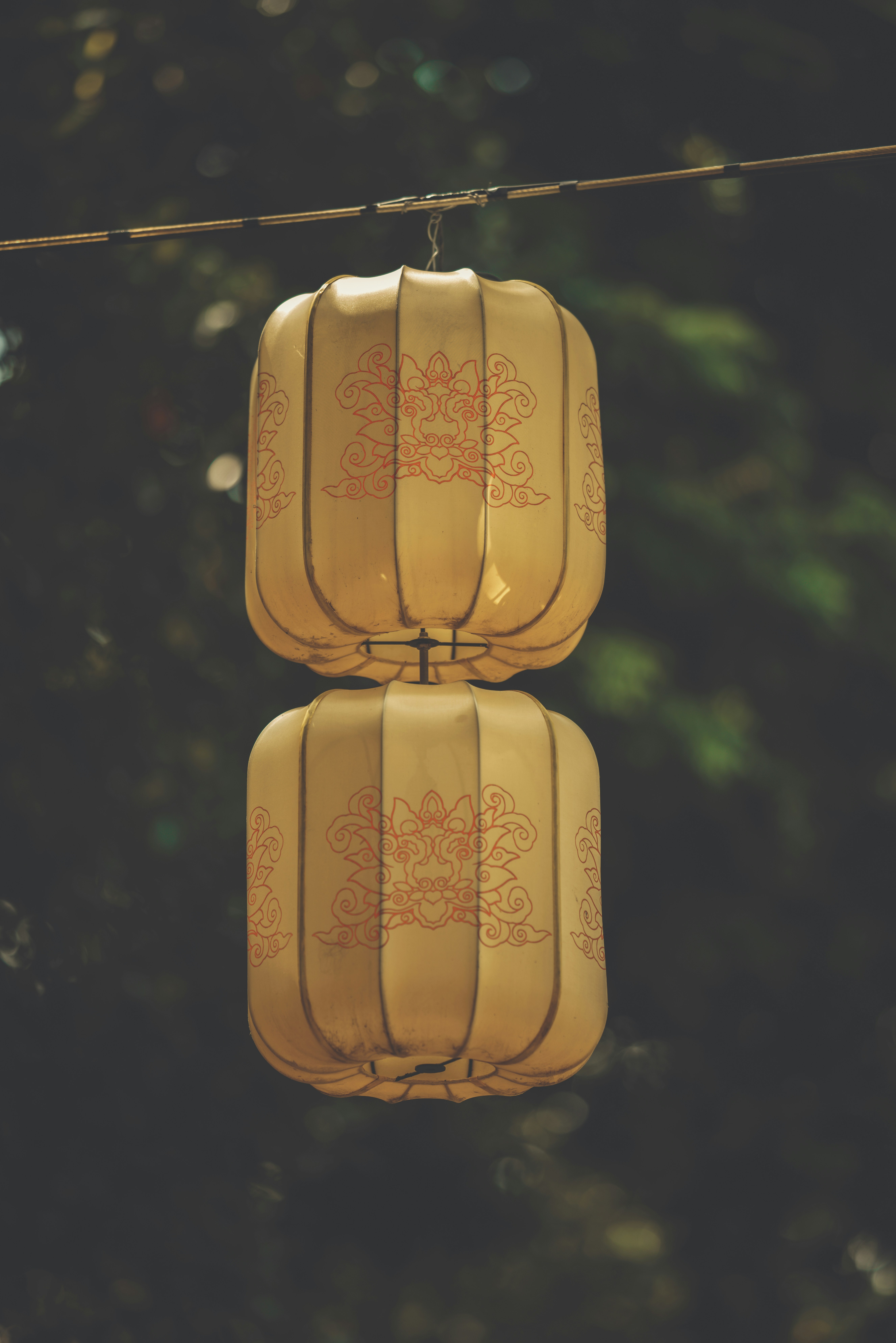 Two stacked chinese lanterns hang outdoors