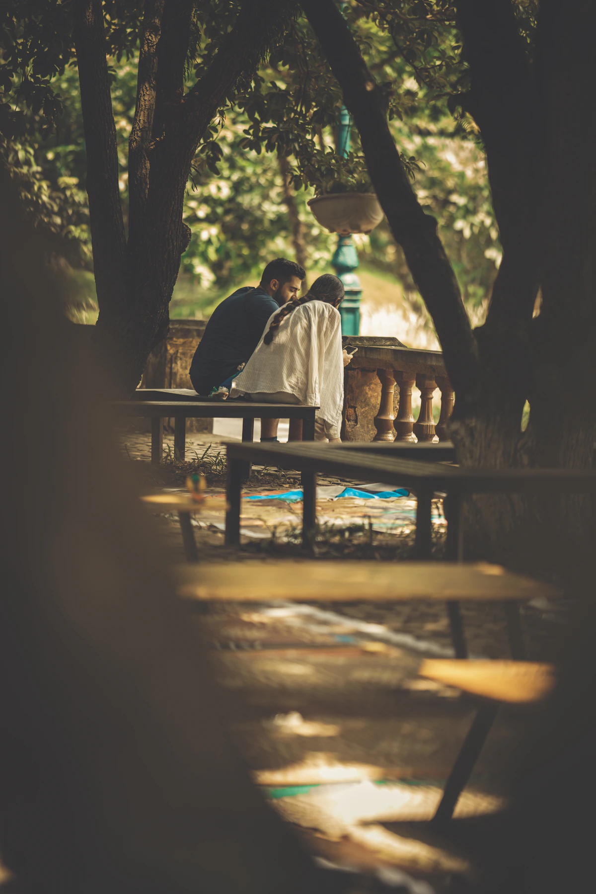 Couple sitting together on a bench in a park, representing the reconnection couples therapy can help build