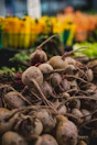 Freshly harvested beets piled at a market stall.