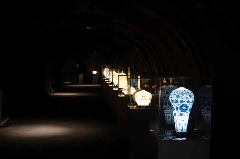 row-of-illuminated-vases-in-a-dark-museum-hall