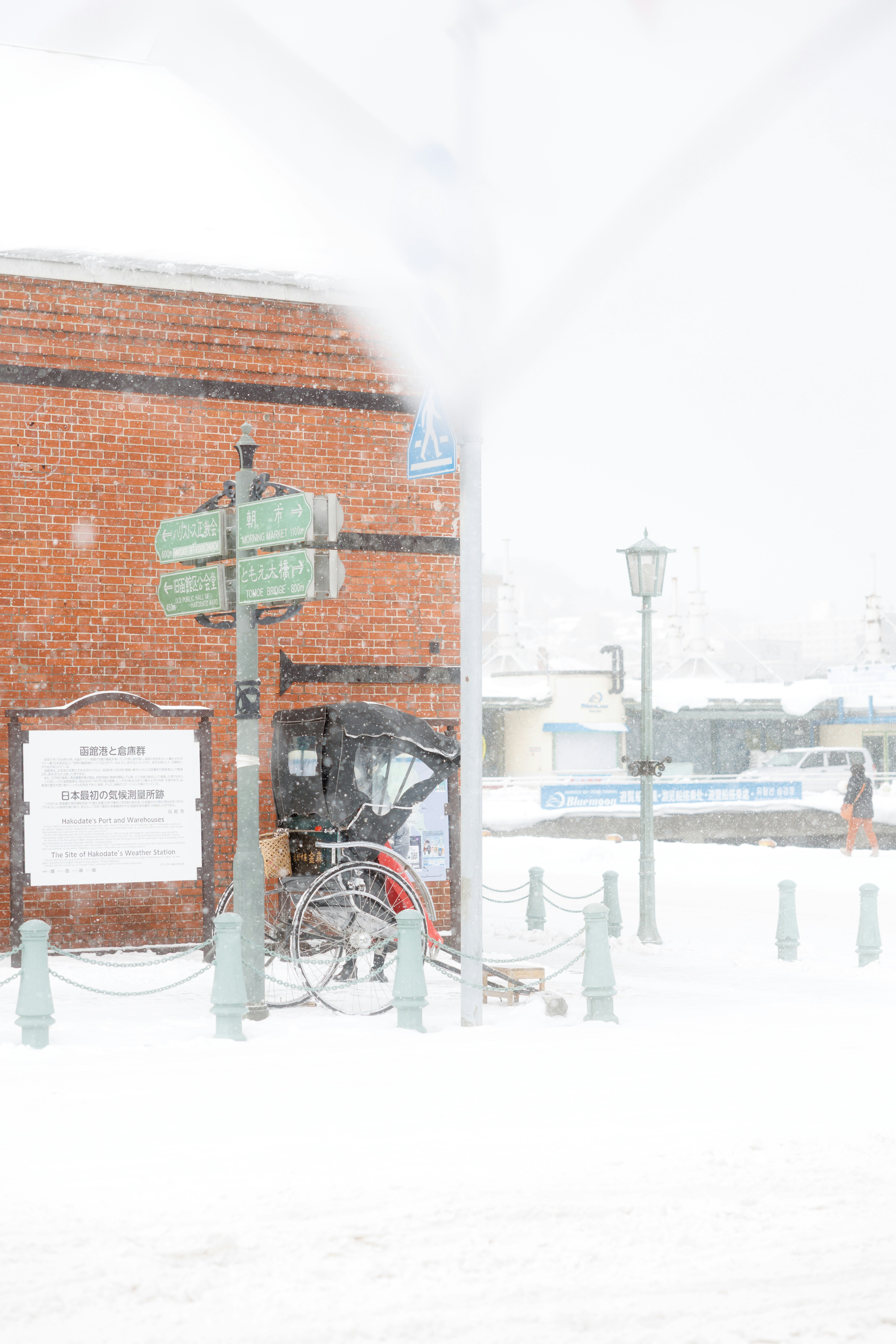 Brick building with horse carriage in snowy weather