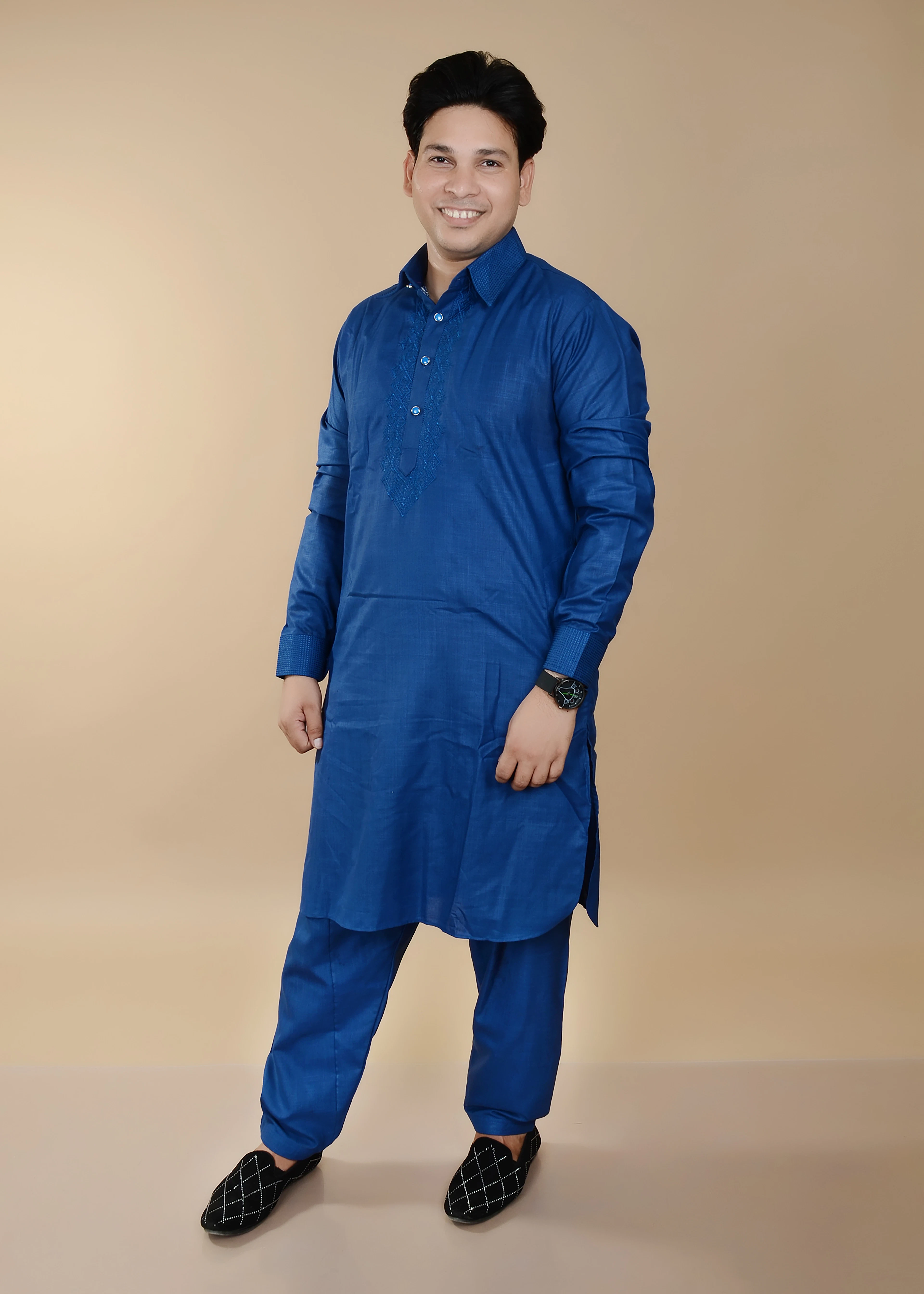 Man in a cobalt blue pathani kurta and trousers
