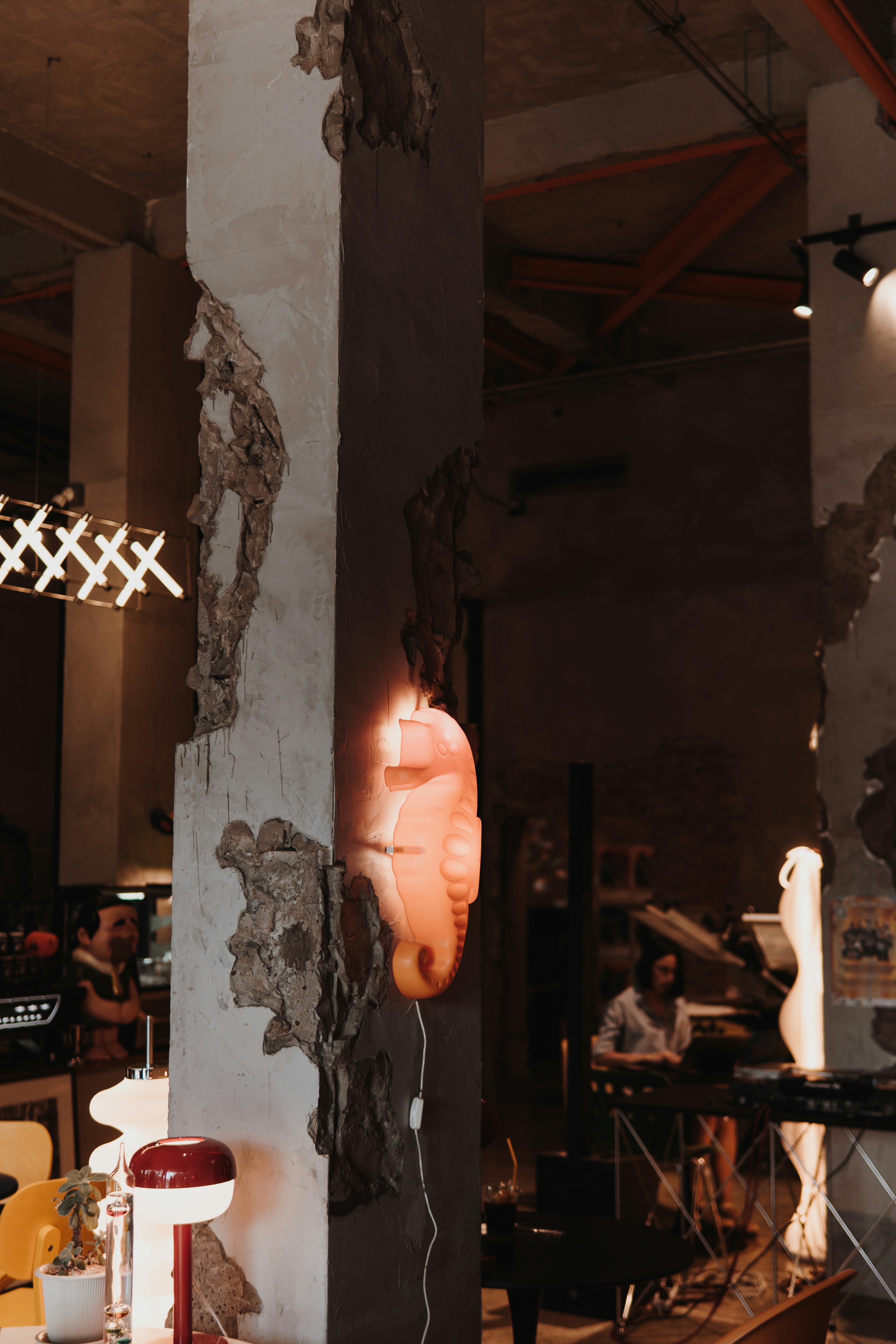 Seahorse lamp illuminates a rustic interior space.