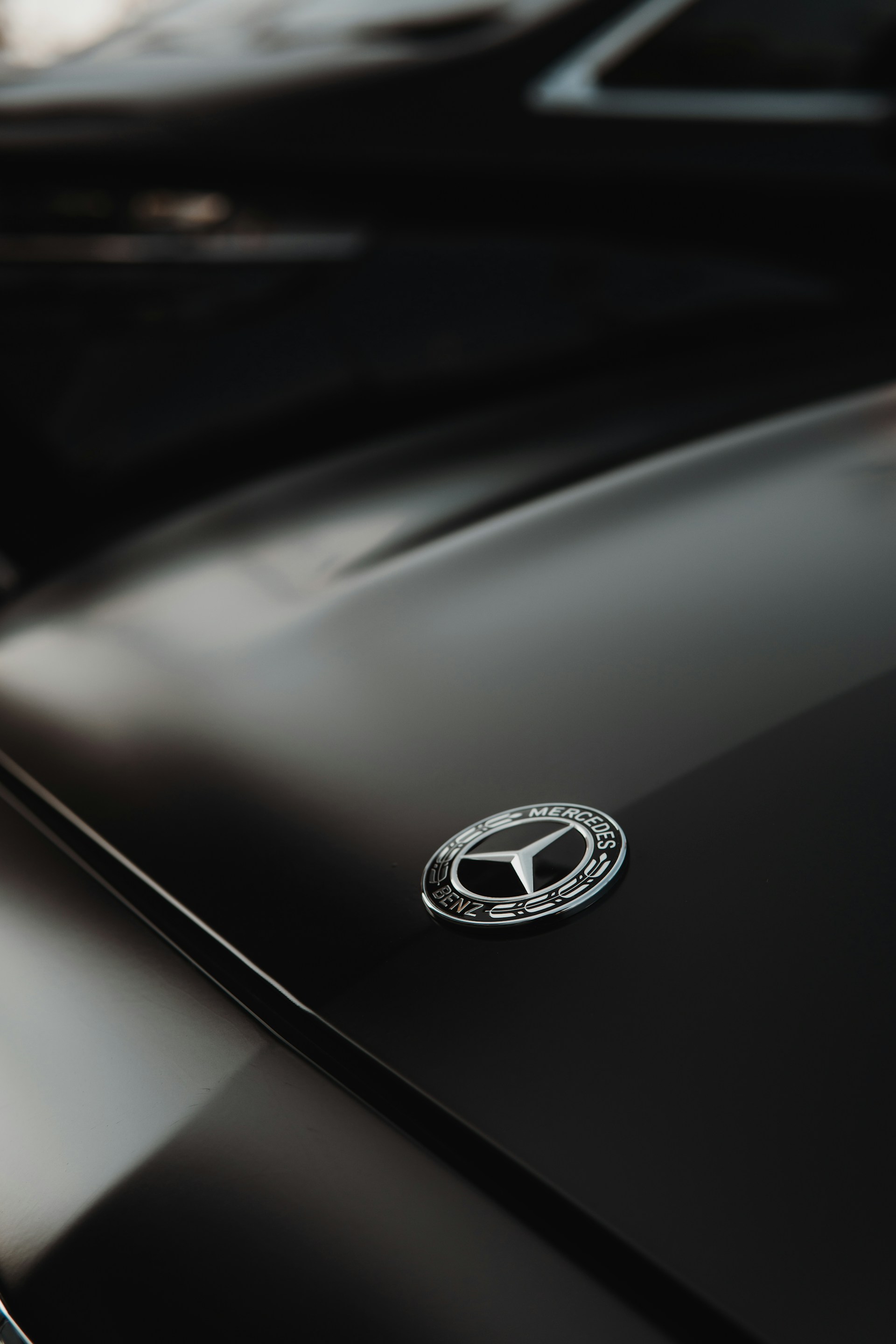 Close-up of a mercedes-benz emblem on a black car
