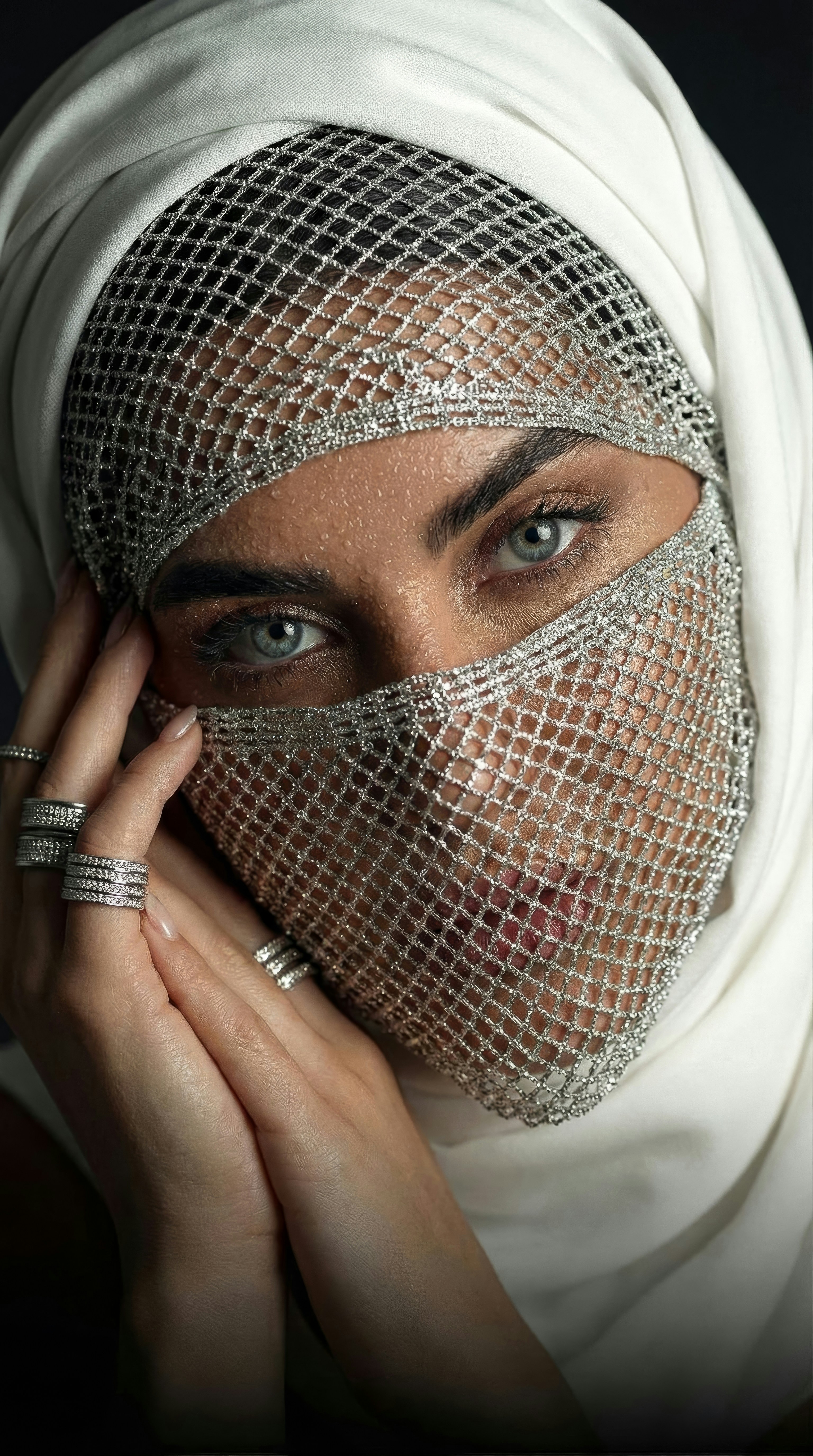 Woman in white hijab and jeweled face mask