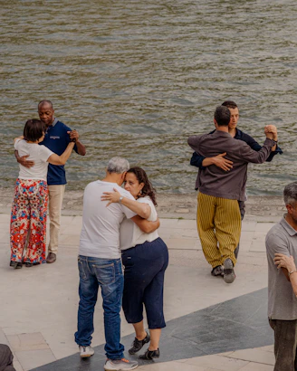 Couples dancing tango by the water