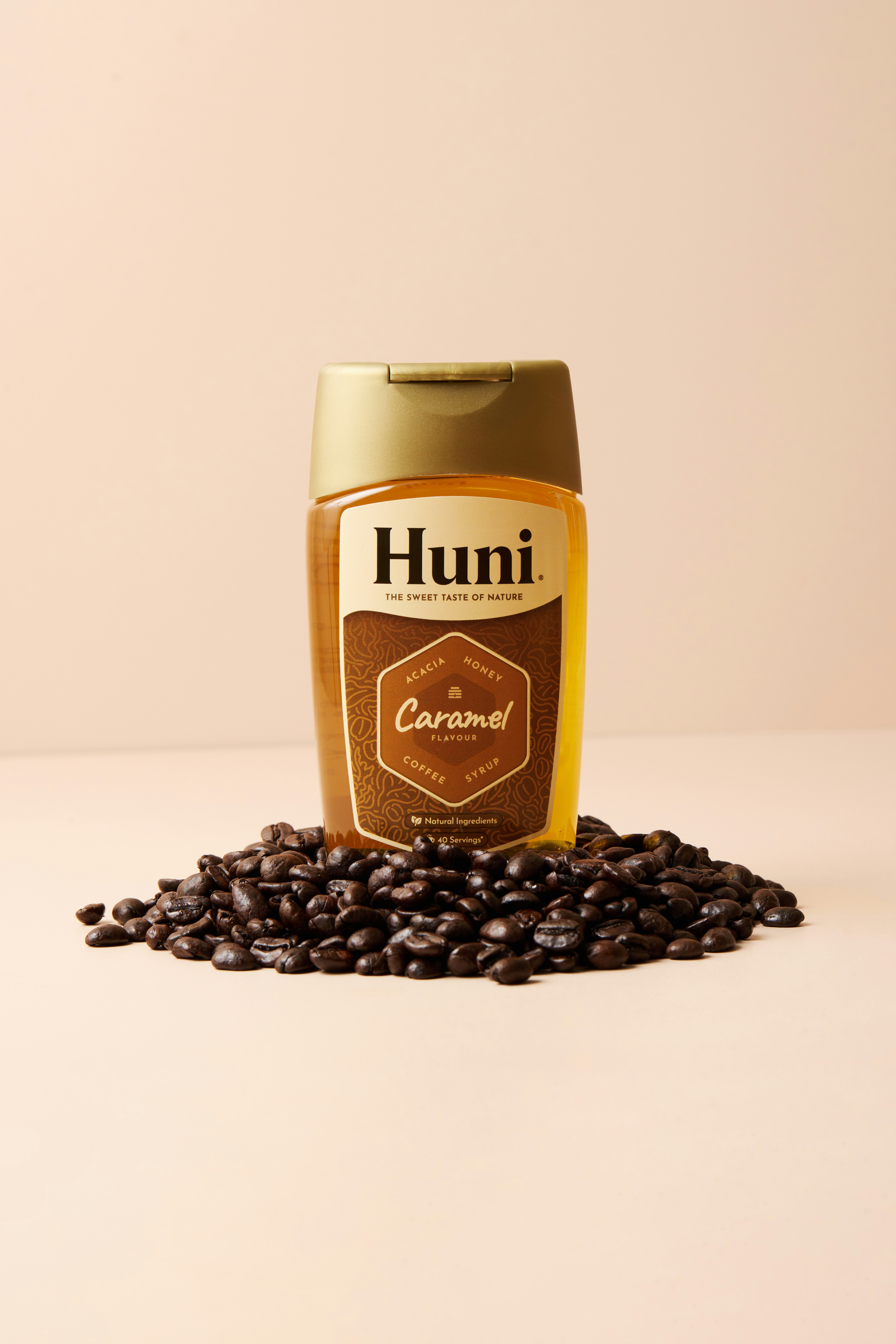 A jar of huni caramel coffee creamer with coffee beans