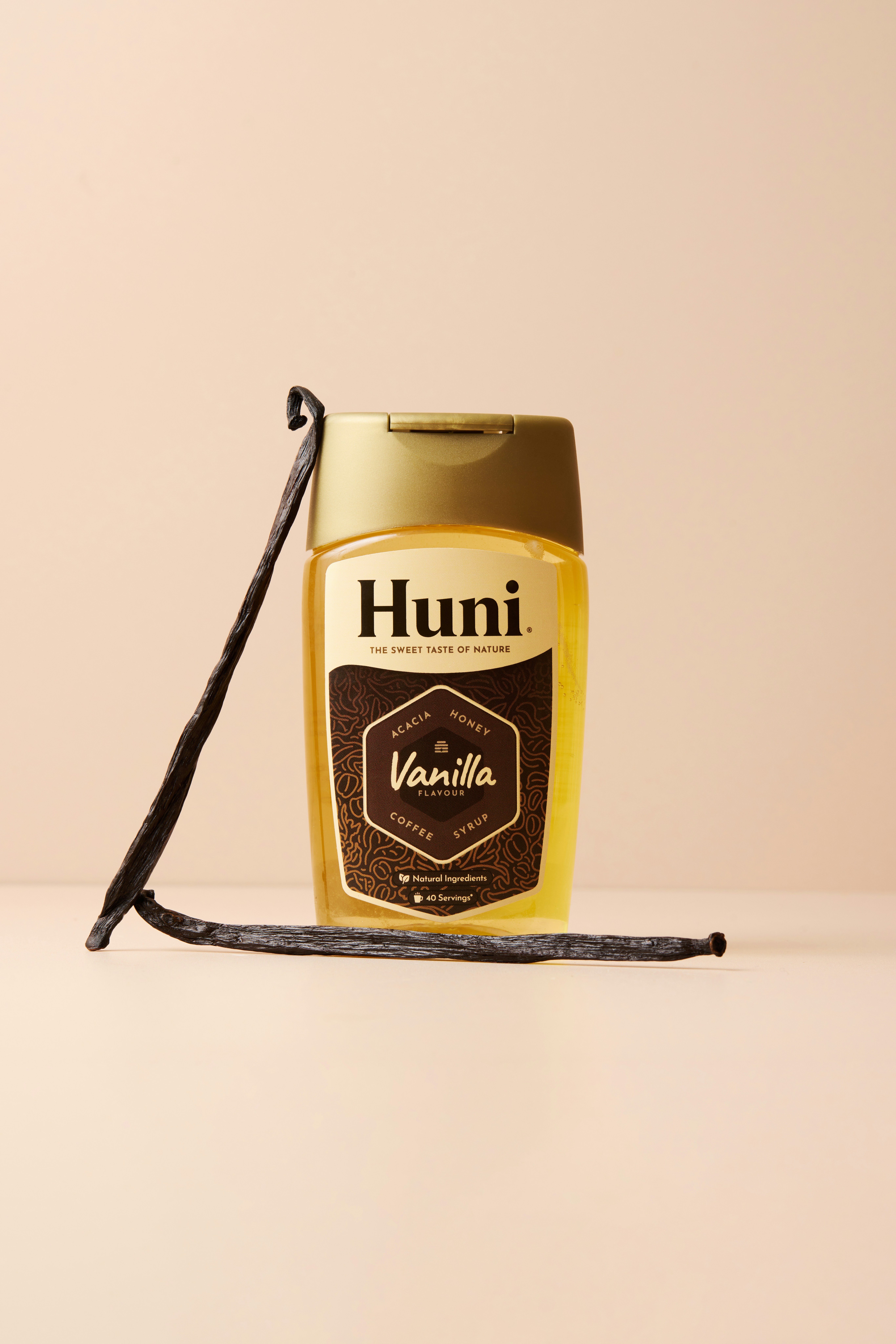 Bottle of huni vanilla syrup with vanilla beans