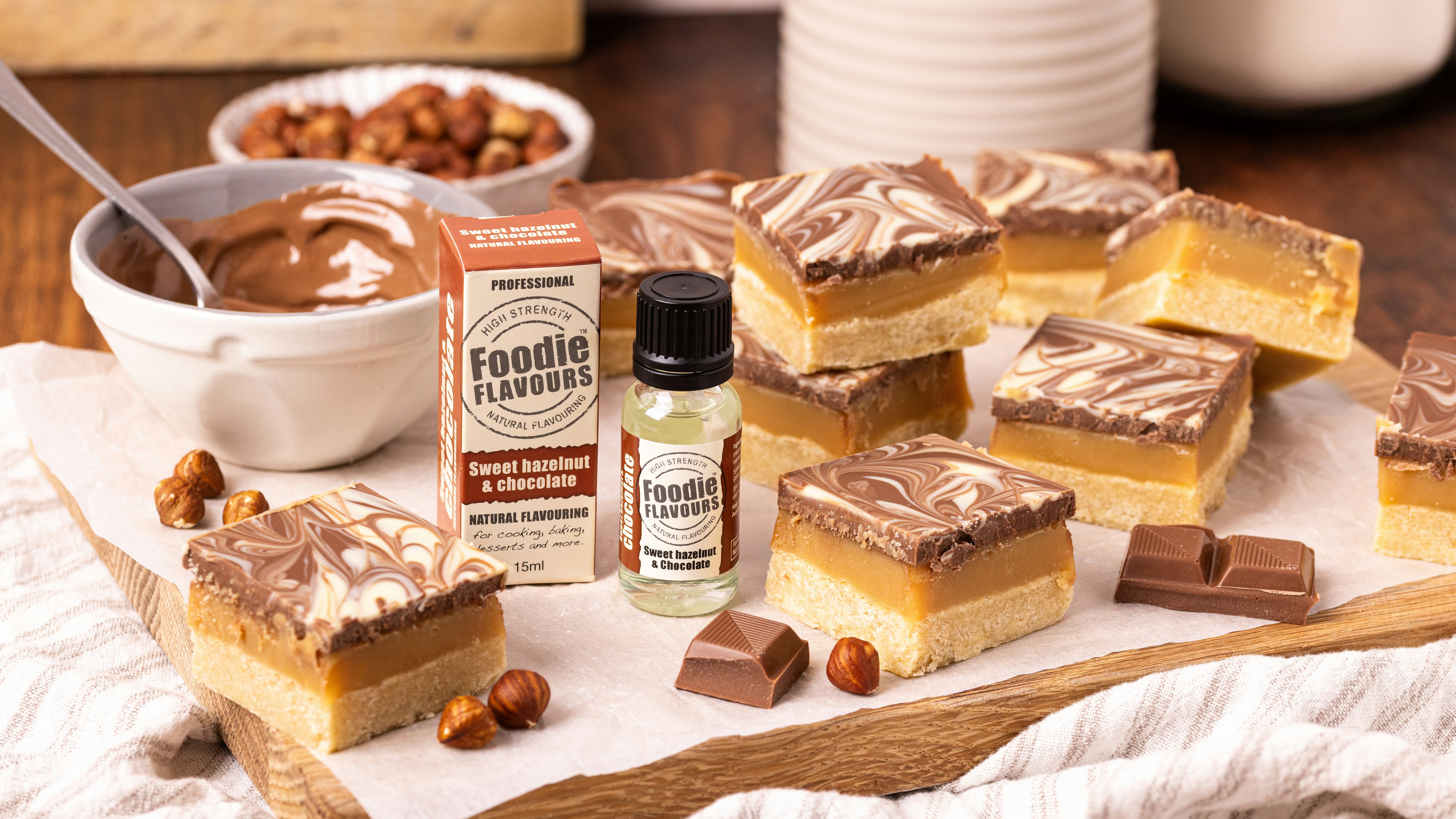Square caramel slices with chocolate swirls and hazelnuts