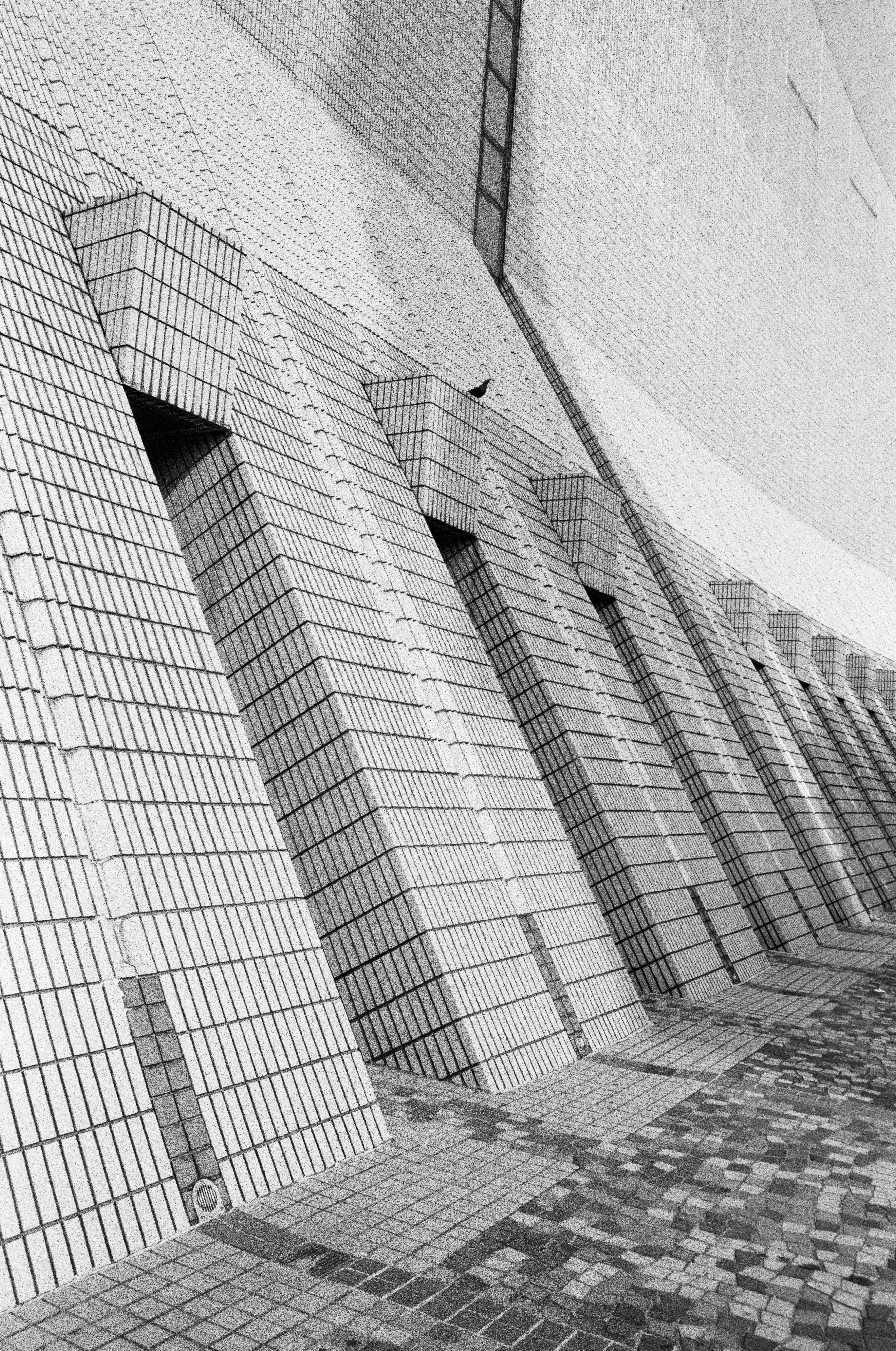 Tiled building facade with repeating geometric patterns