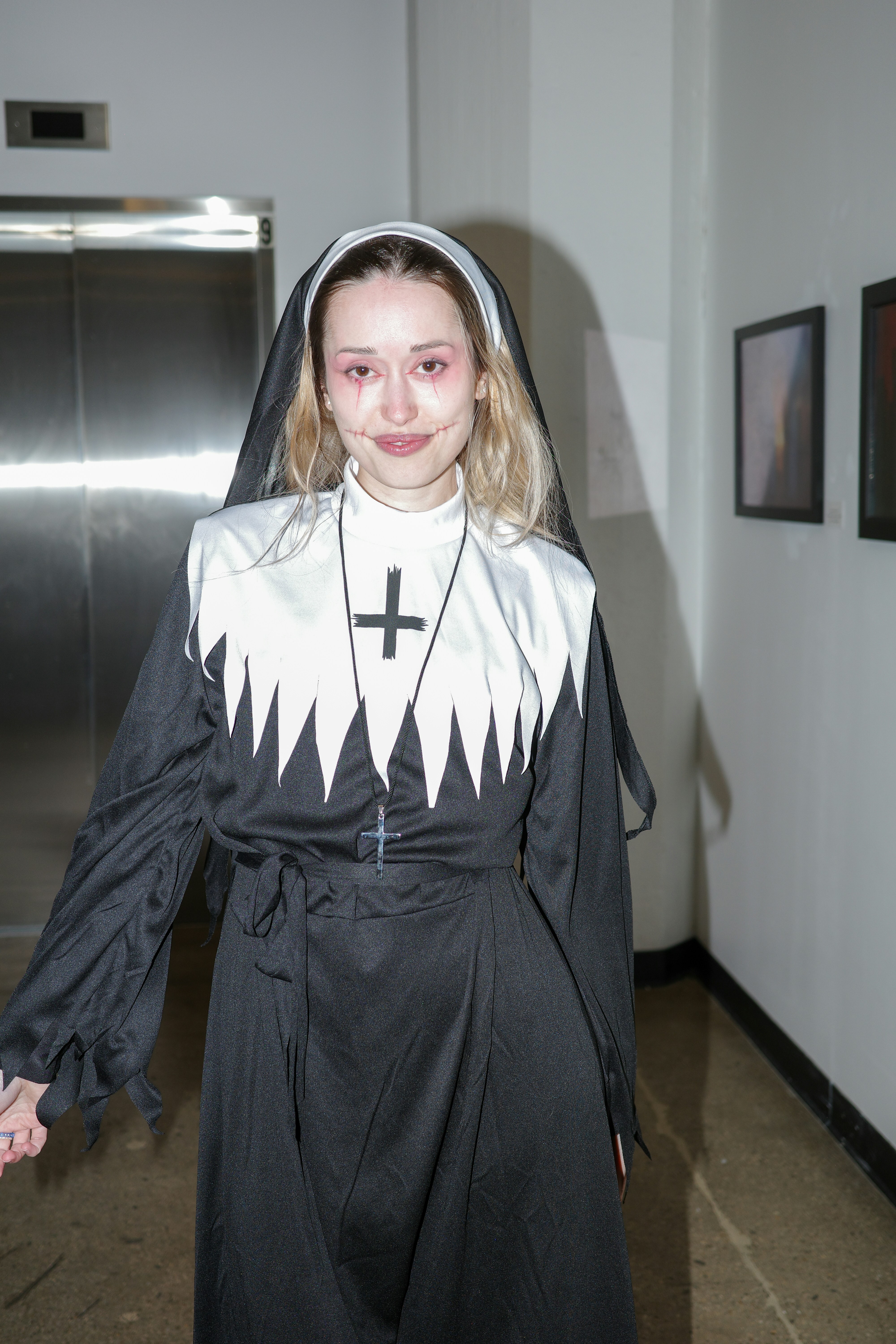 Young woman in a nun costume with dramatic makeup